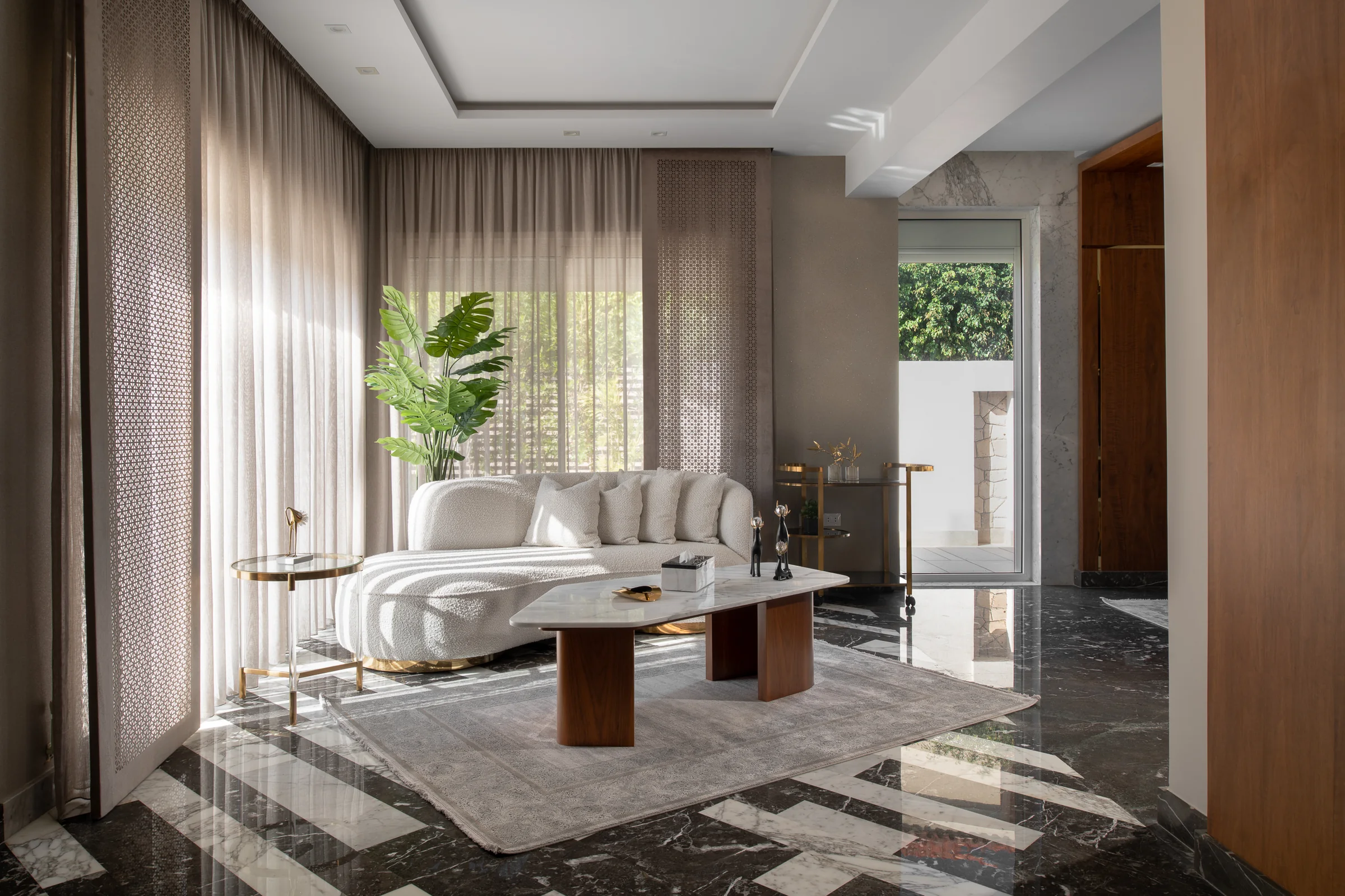 Living room wide, sheer curtains along the garden wall.