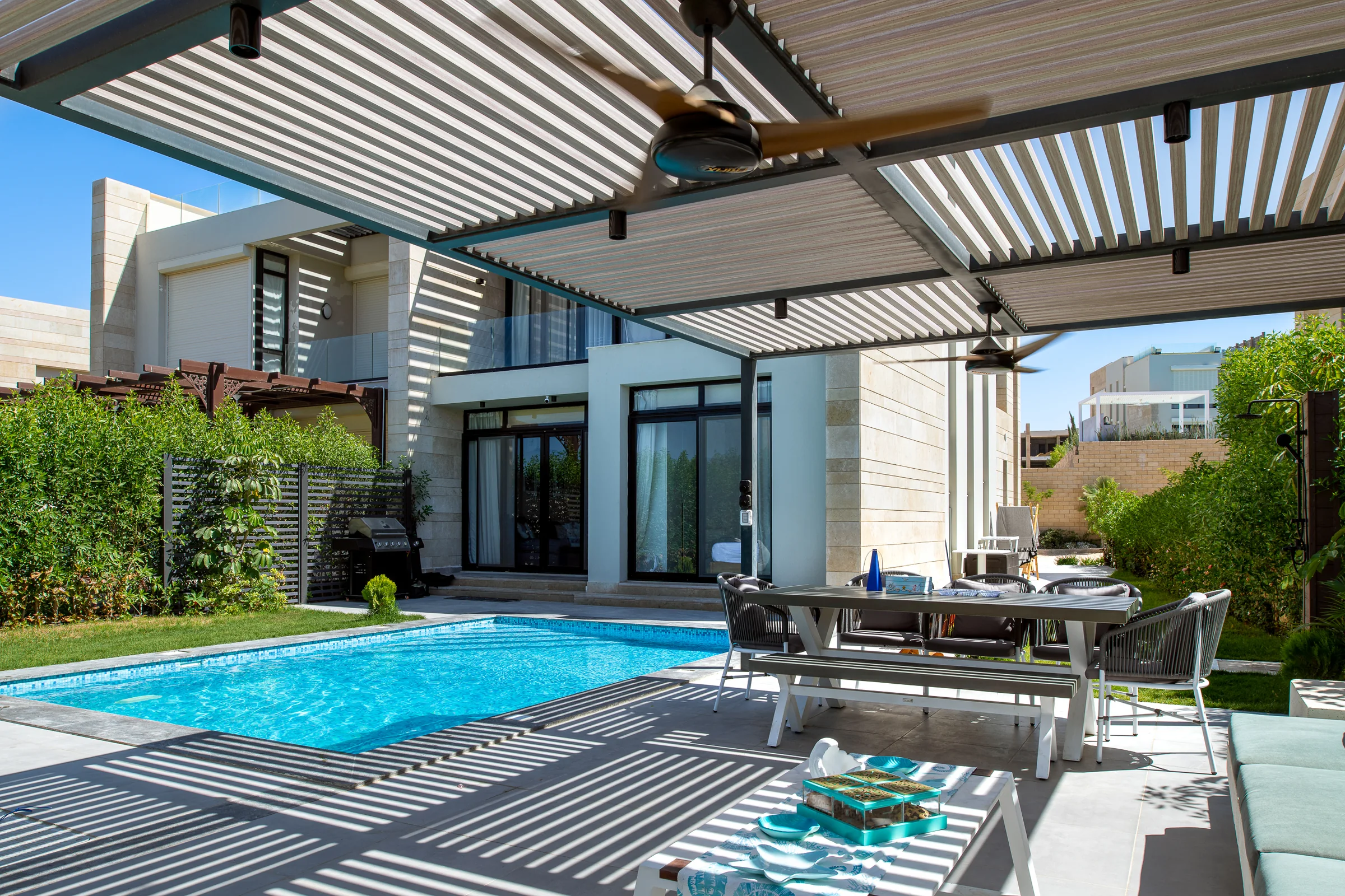Pool and terrace with the pergola running the length of the house.