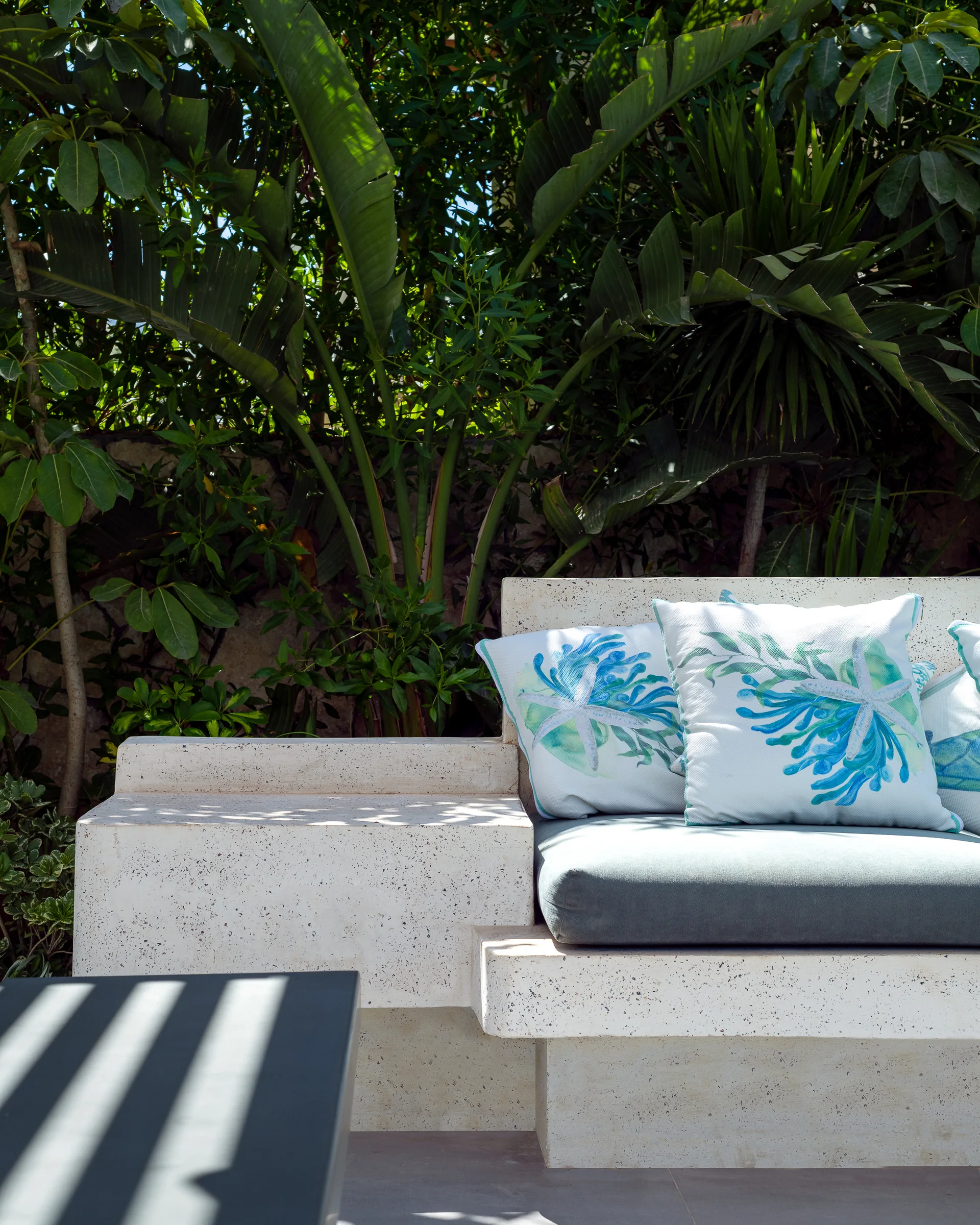 Bench detail: concrete, cushion and planting.