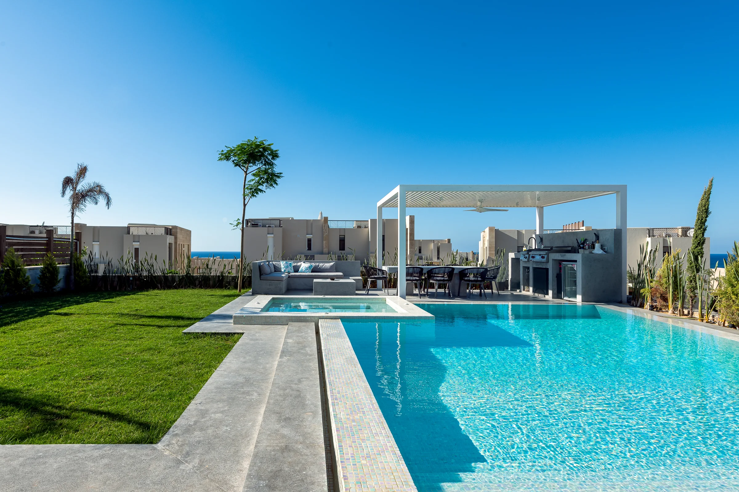 The pool from the lawn, sea on the horizon.