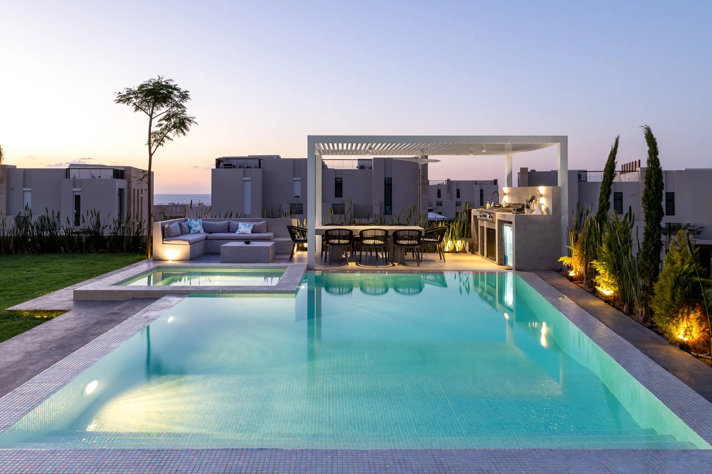 The pool at dusk, the lights coming up.