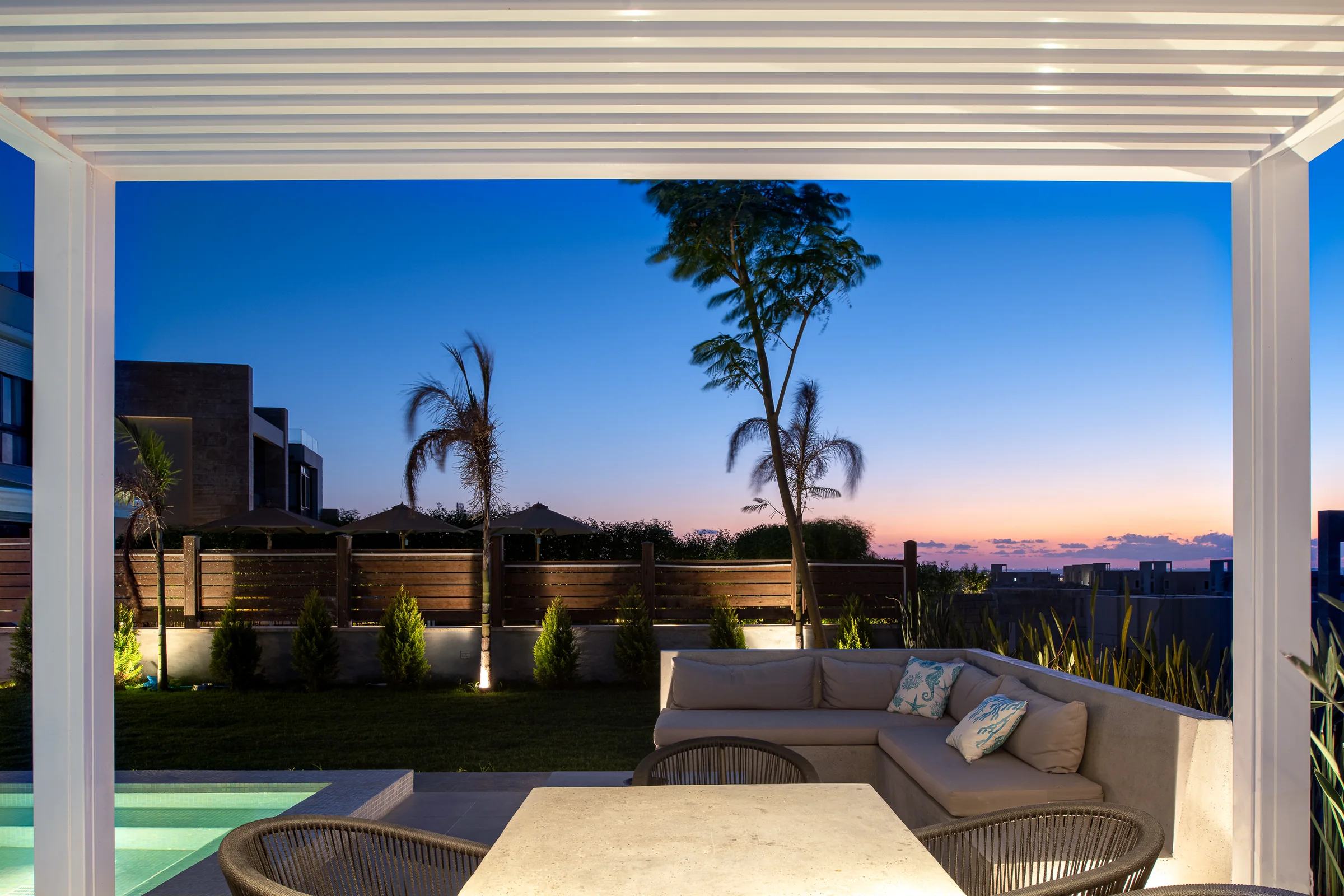Sunset from under the pergola, the coastline beyond.