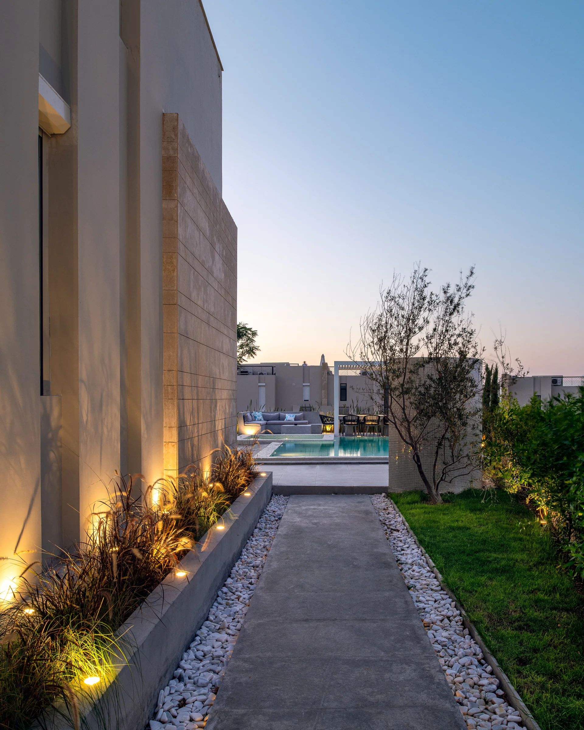 The path between the buildings at dusk.