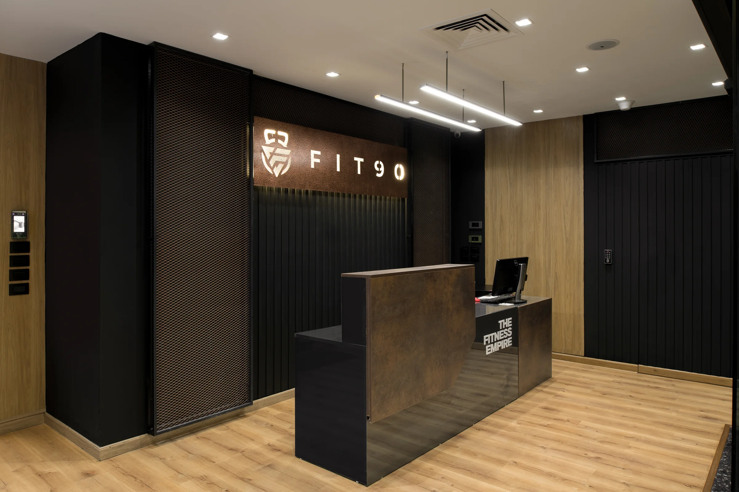 The reception from the entrance, dark joinery against oak.