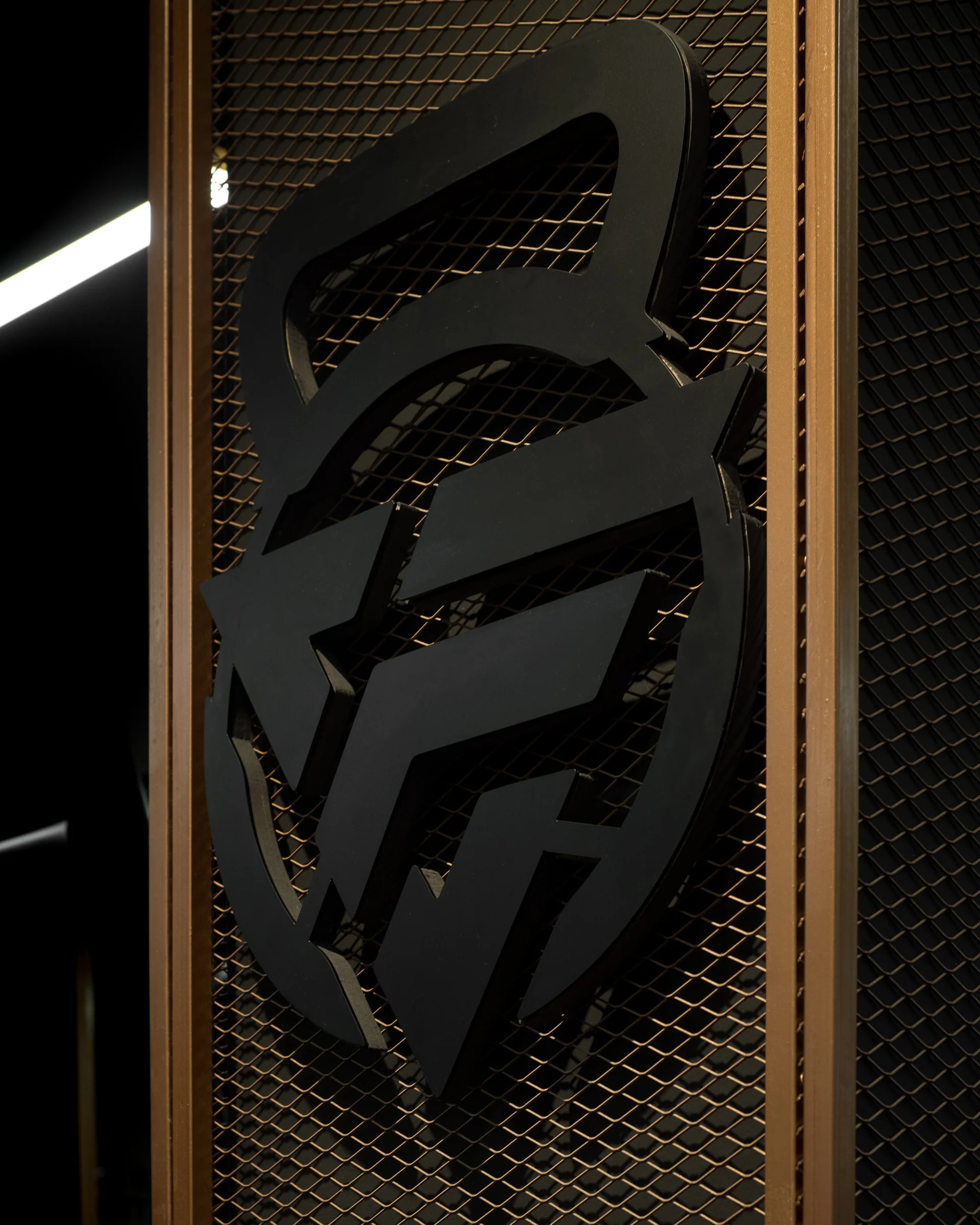 The Fit 90 emblem cut from steel on a perforated screen.