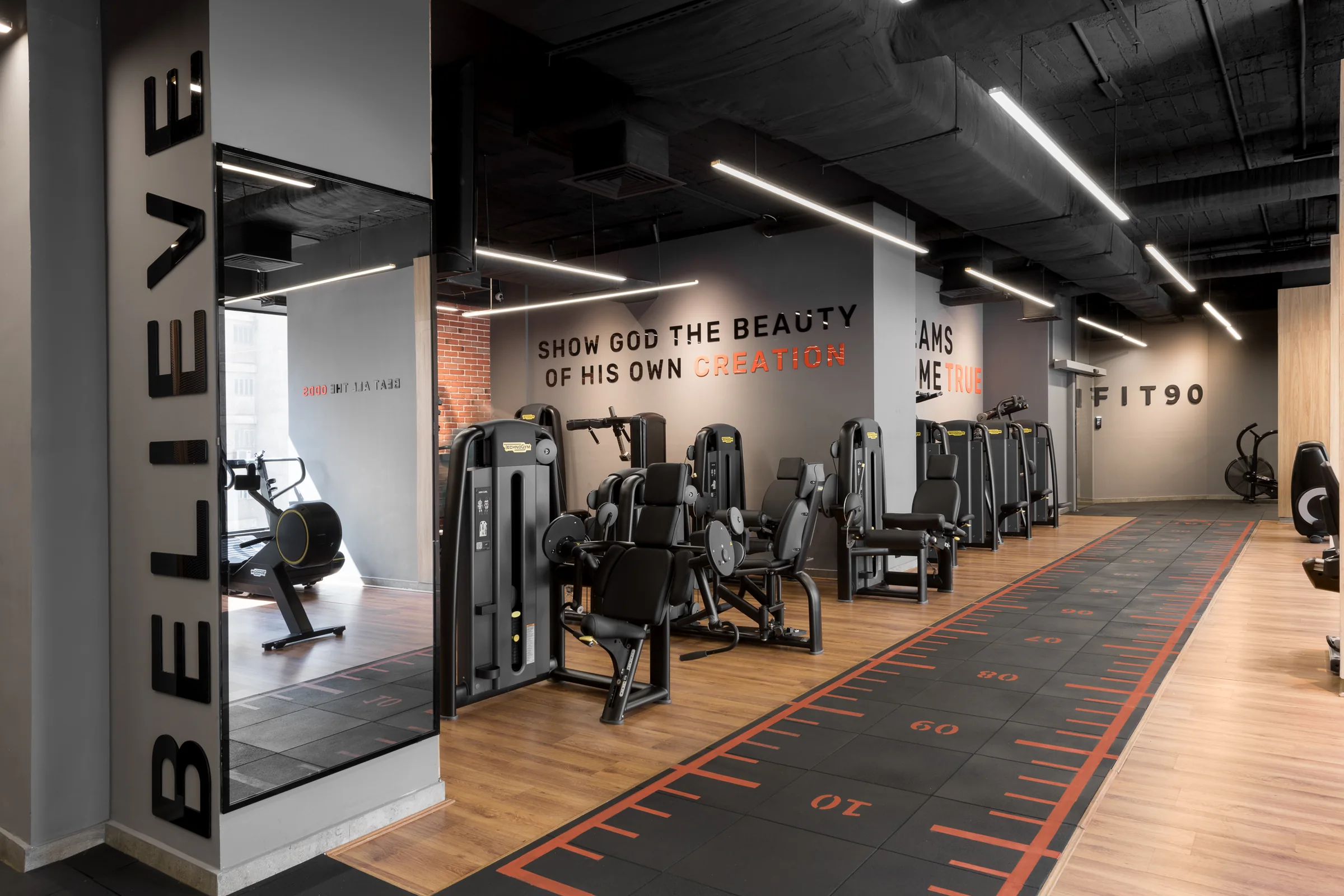 Wide view of the machine floor with wall graphics.