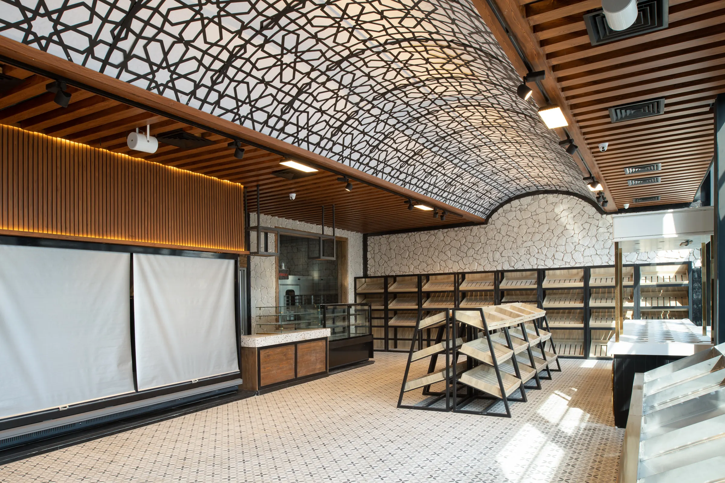The vault from the far end, timber ribs meeting the tiled floor.