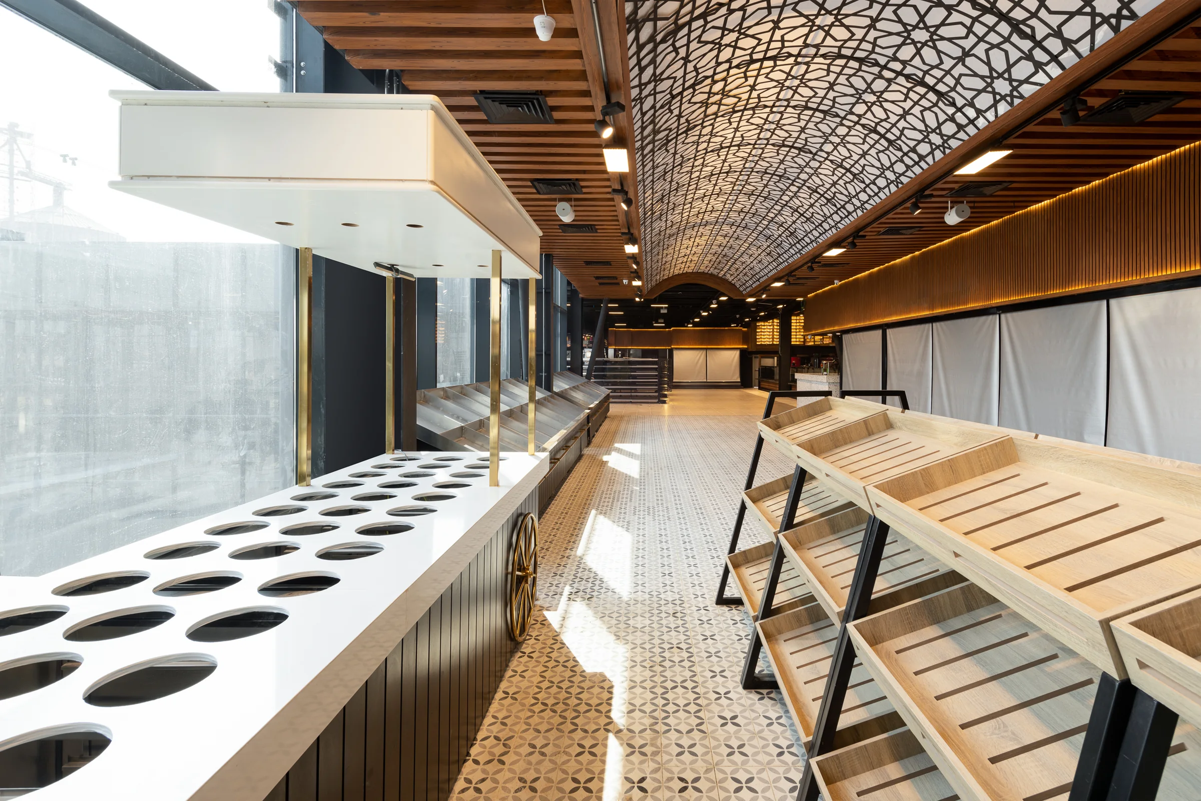 Preparation counter along the vault, shelving beyond.
