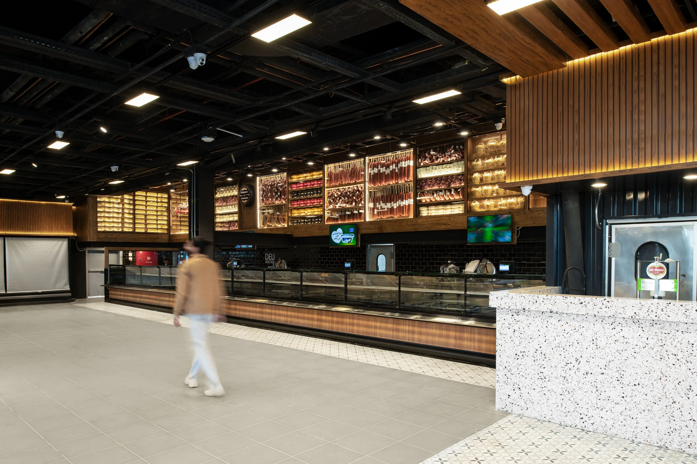 The market in use, a customer crossing the aisle.