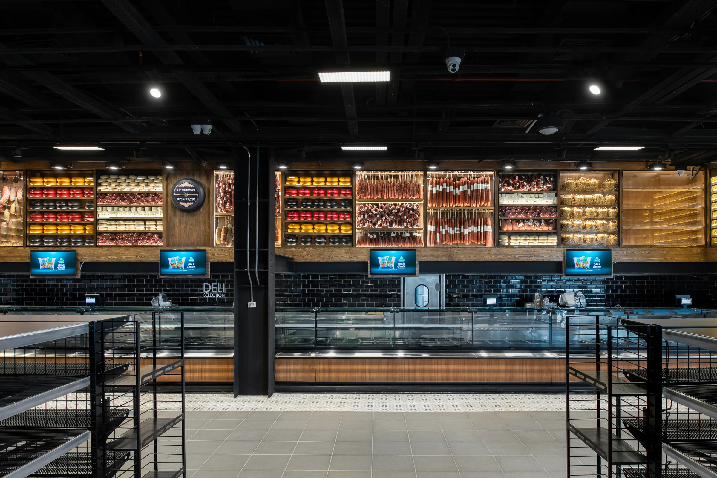 The delicatessen wall with its screens and hanging stock.