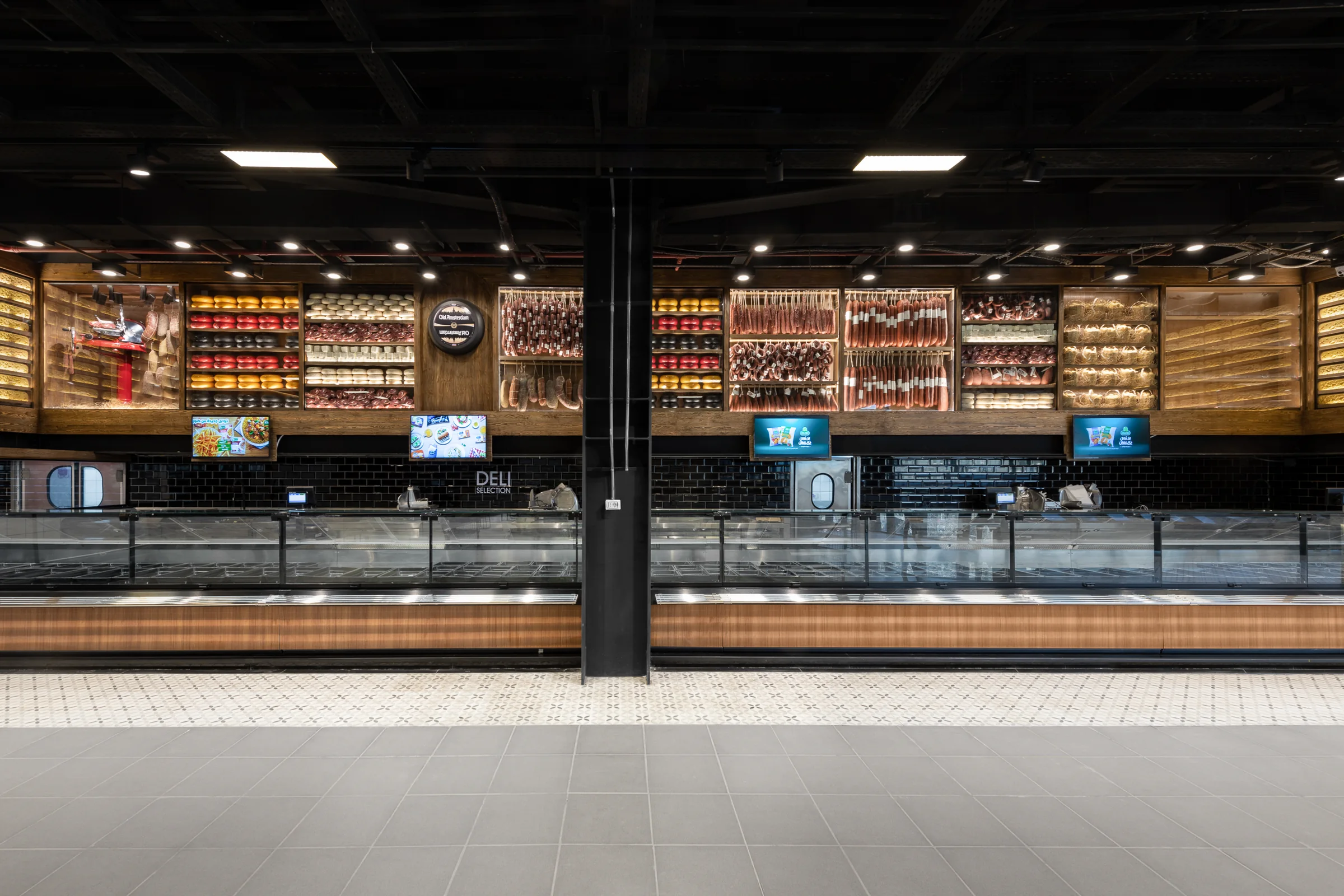 The full run of the counter, timber and black tile.