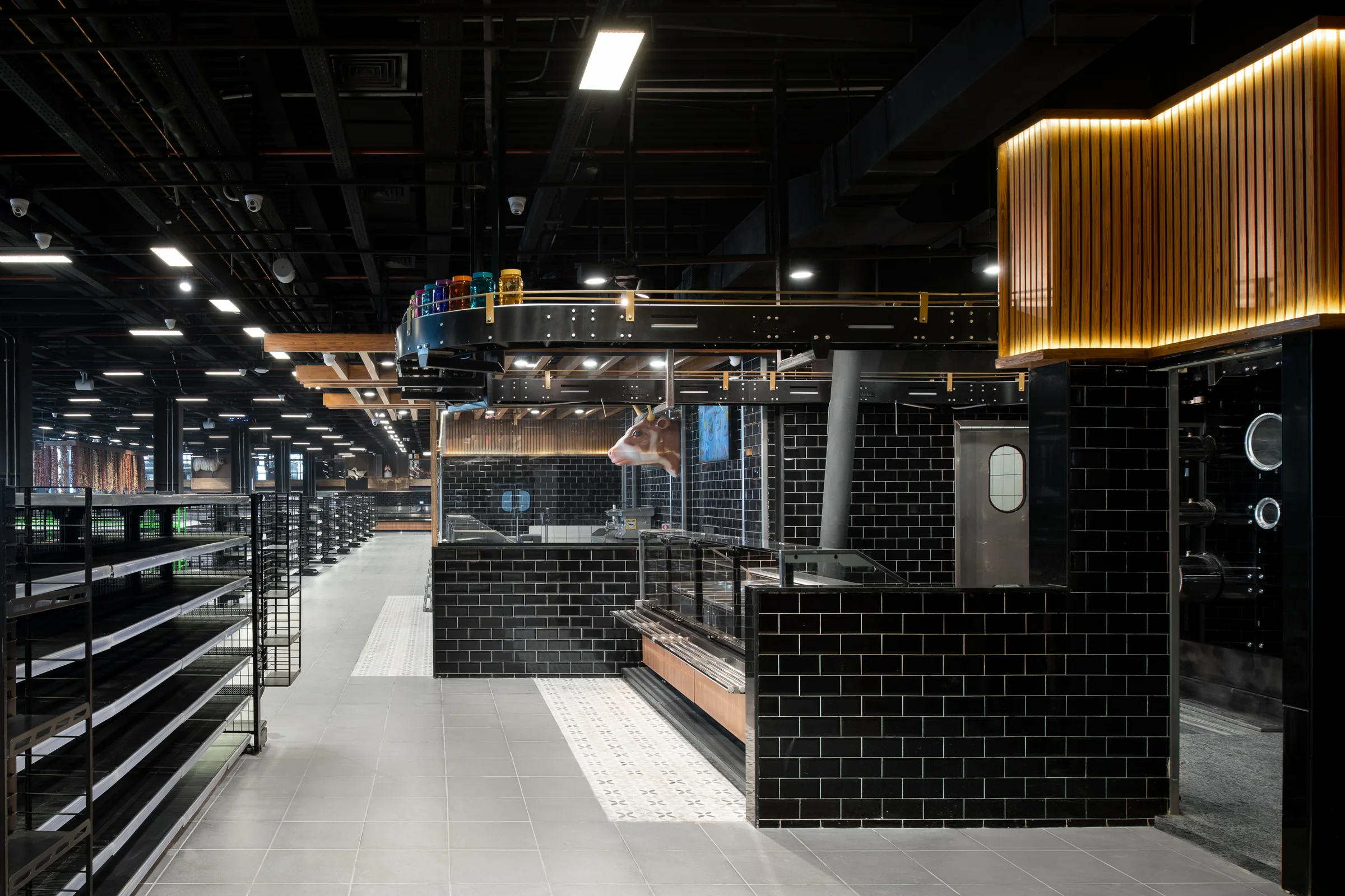 Aisle through the black joinery, fluted timber marking the corner.