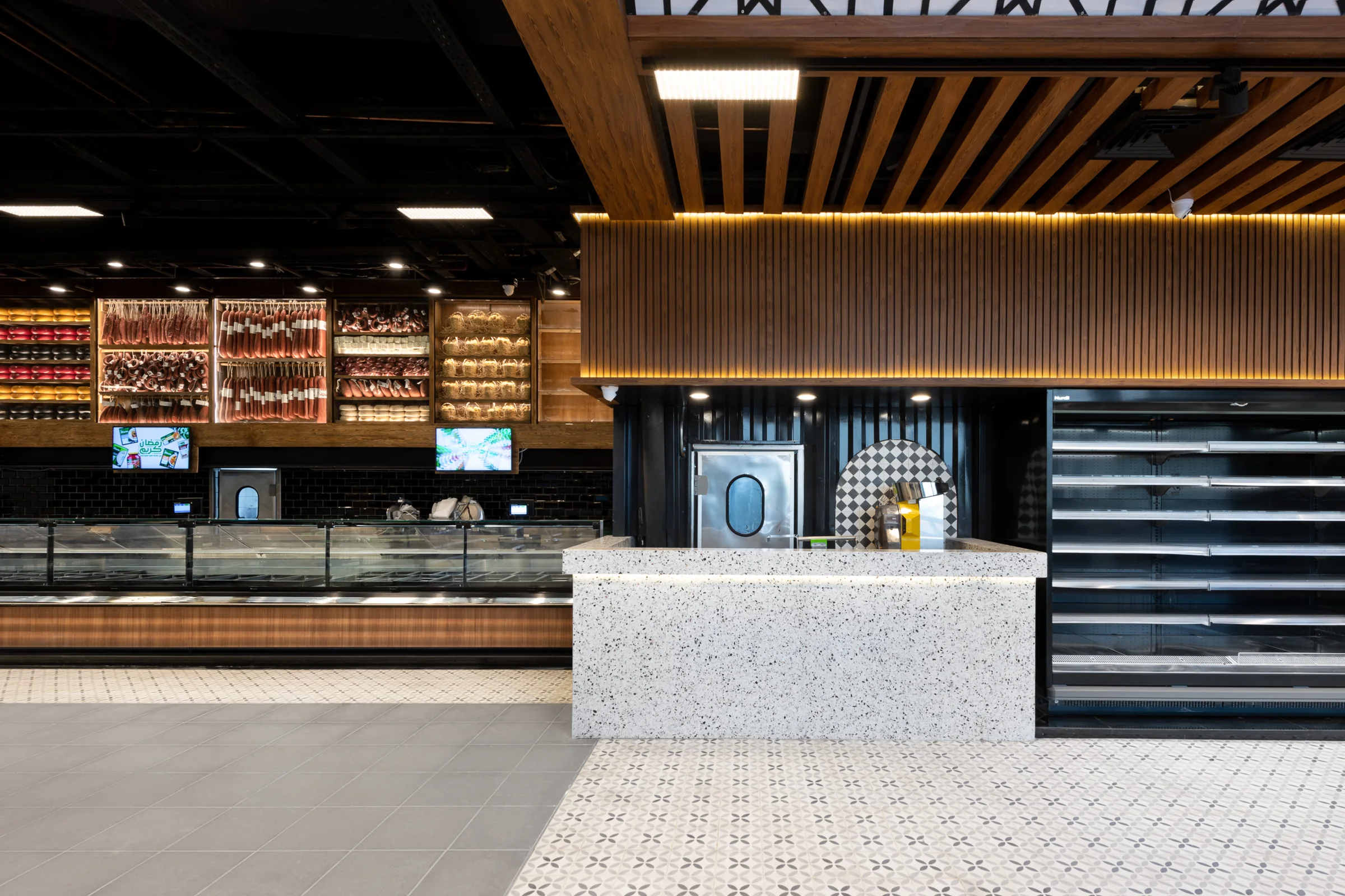 Coffee counter in terrazzo under a slatted timber ceiling.