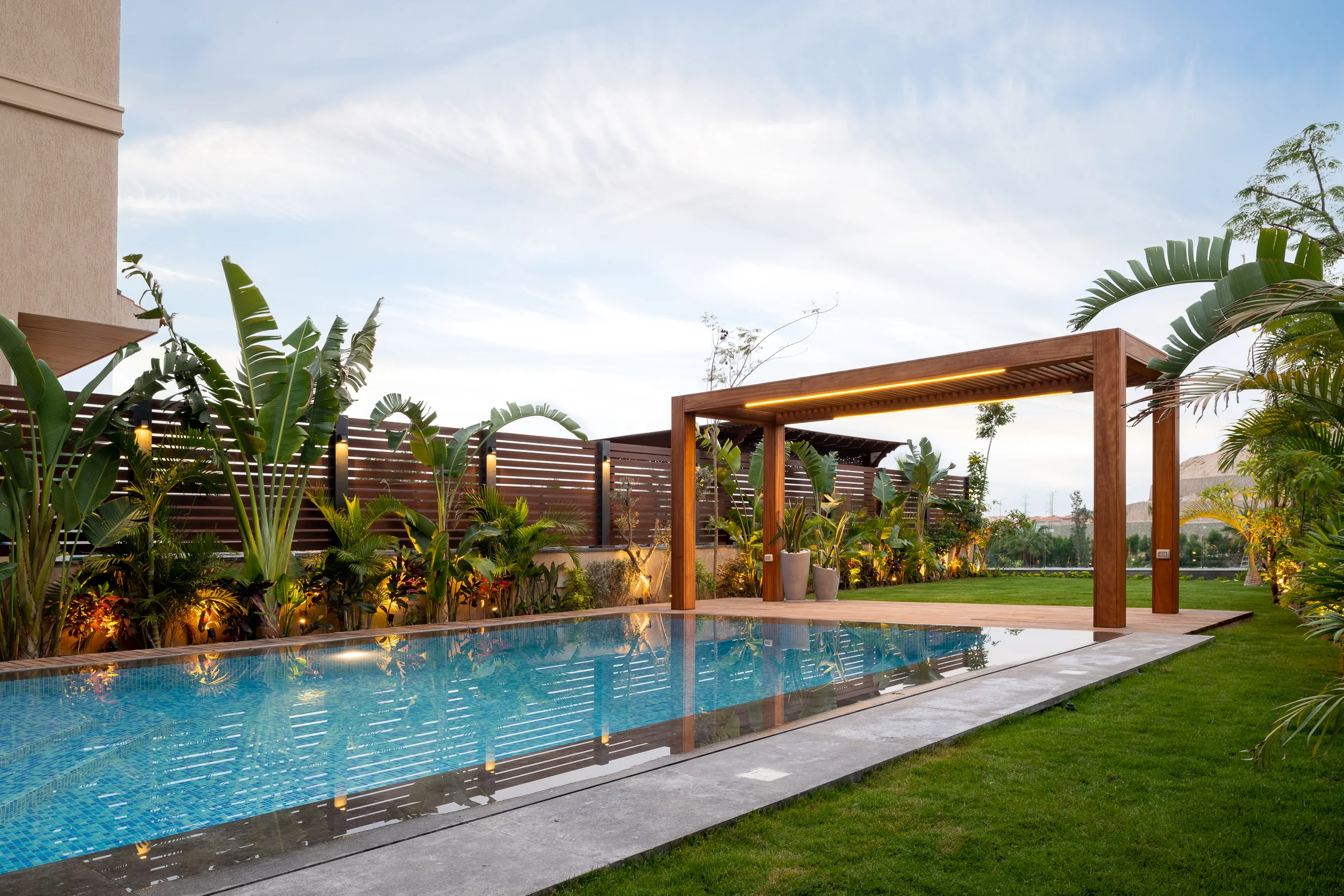 Pool and garden wide, the pergola open to the sky.