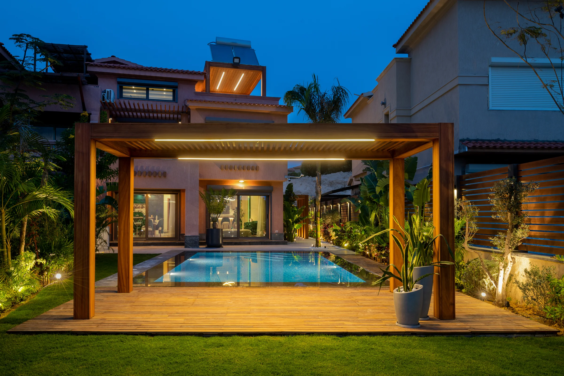 The pergola at dusk over its timber deck.