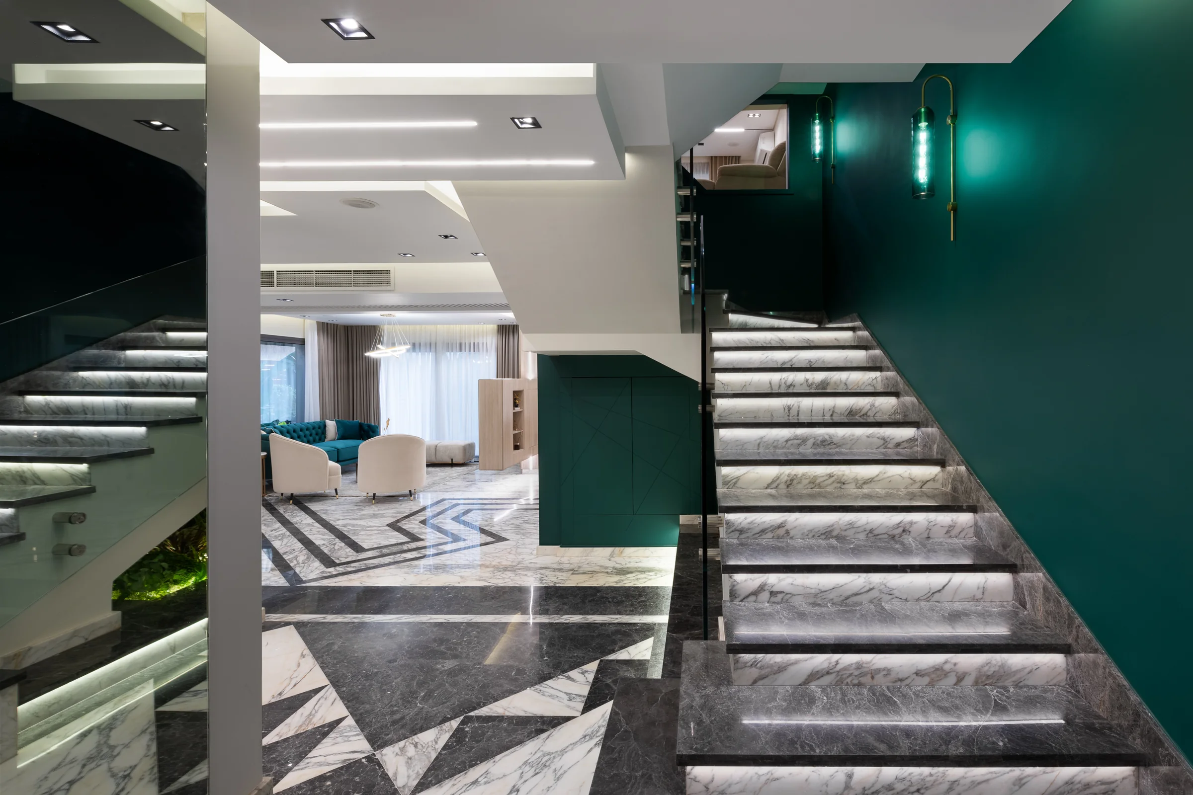 Stair rising past an emerald wall over grey marble.