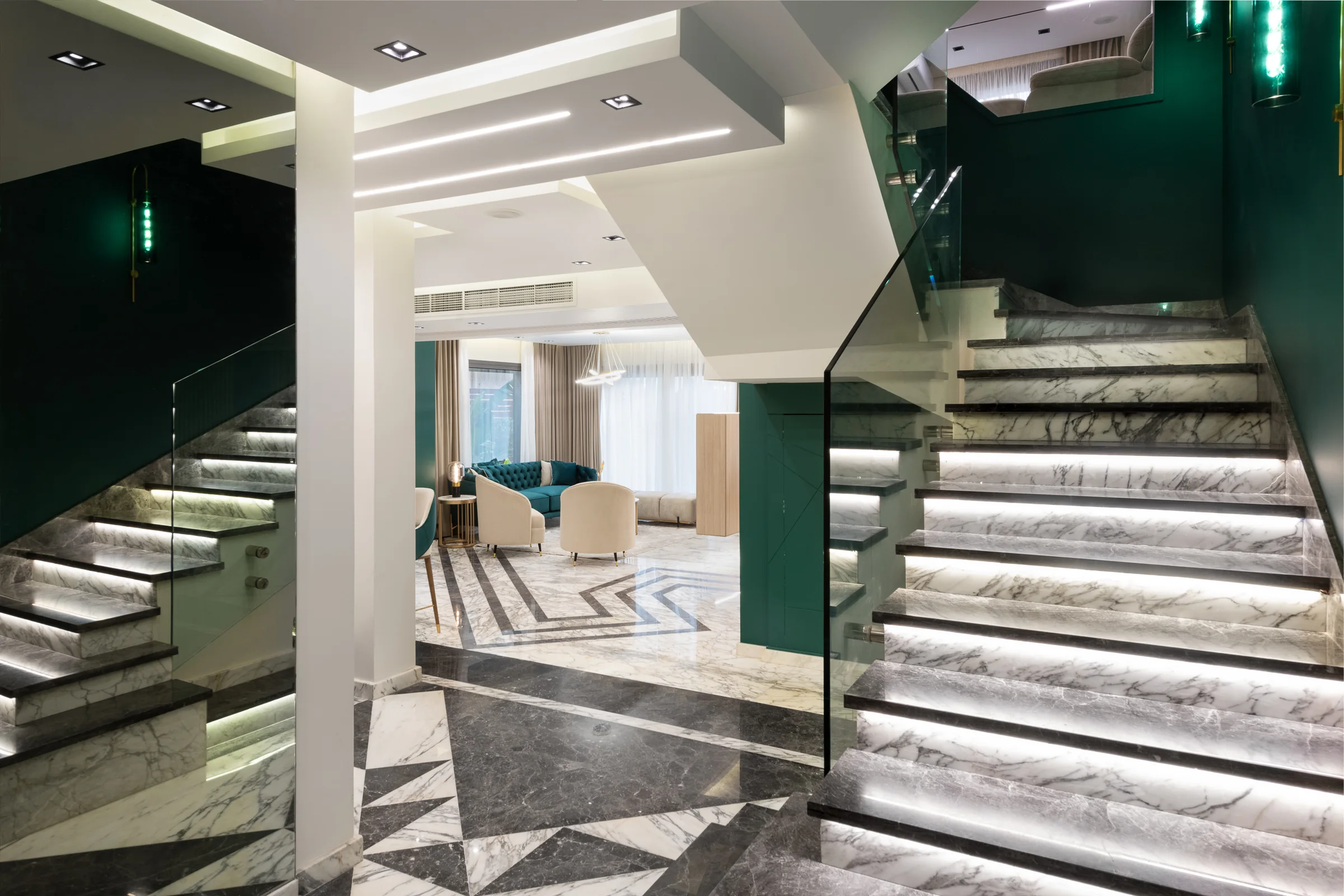The stair hall wide, glass balustrade against white.
