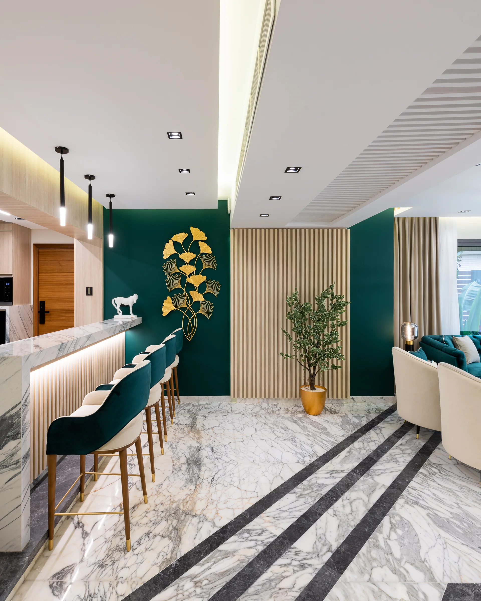 Breakfast counter and stools against the emerald wall.