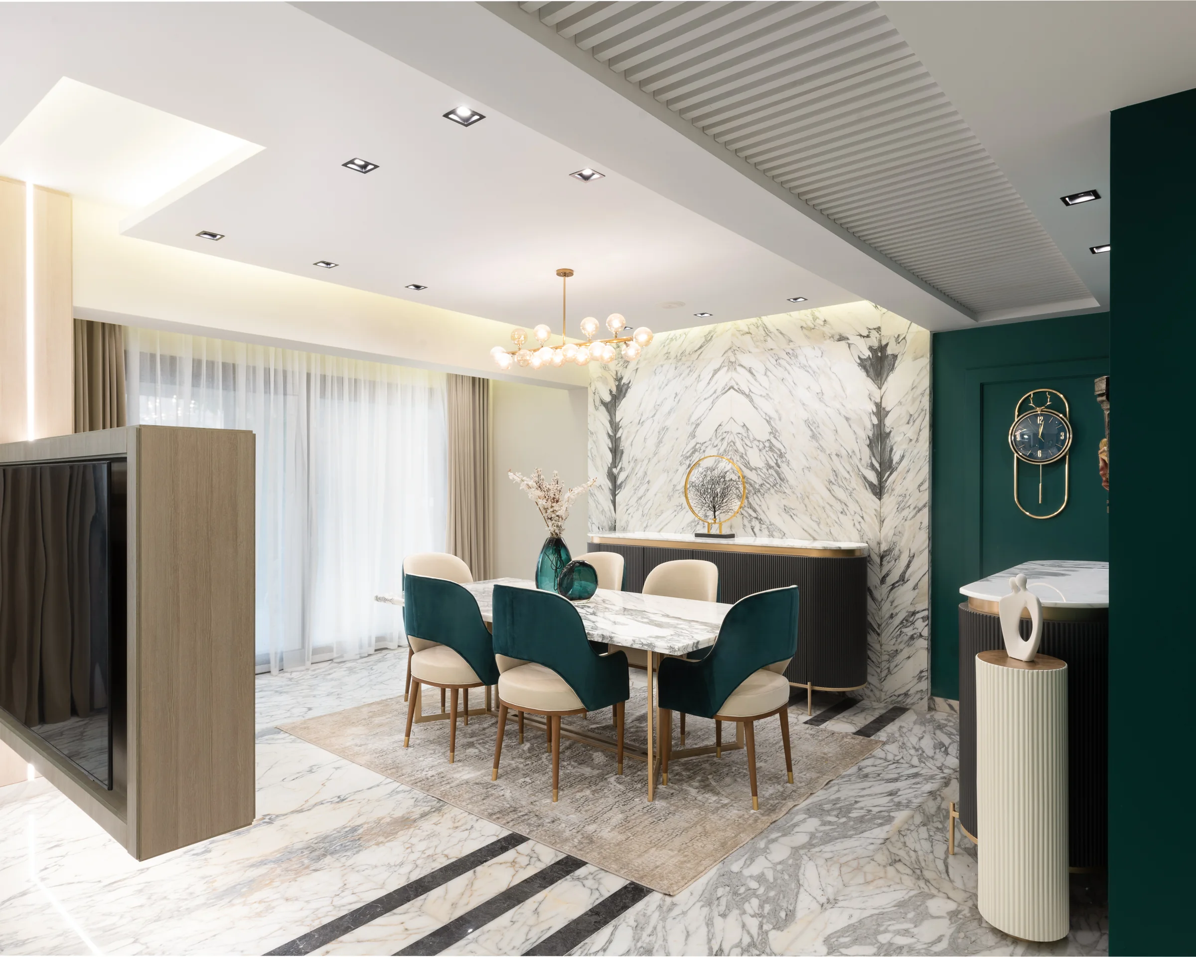 Dining room under its chandelier, book-matched marble behind.