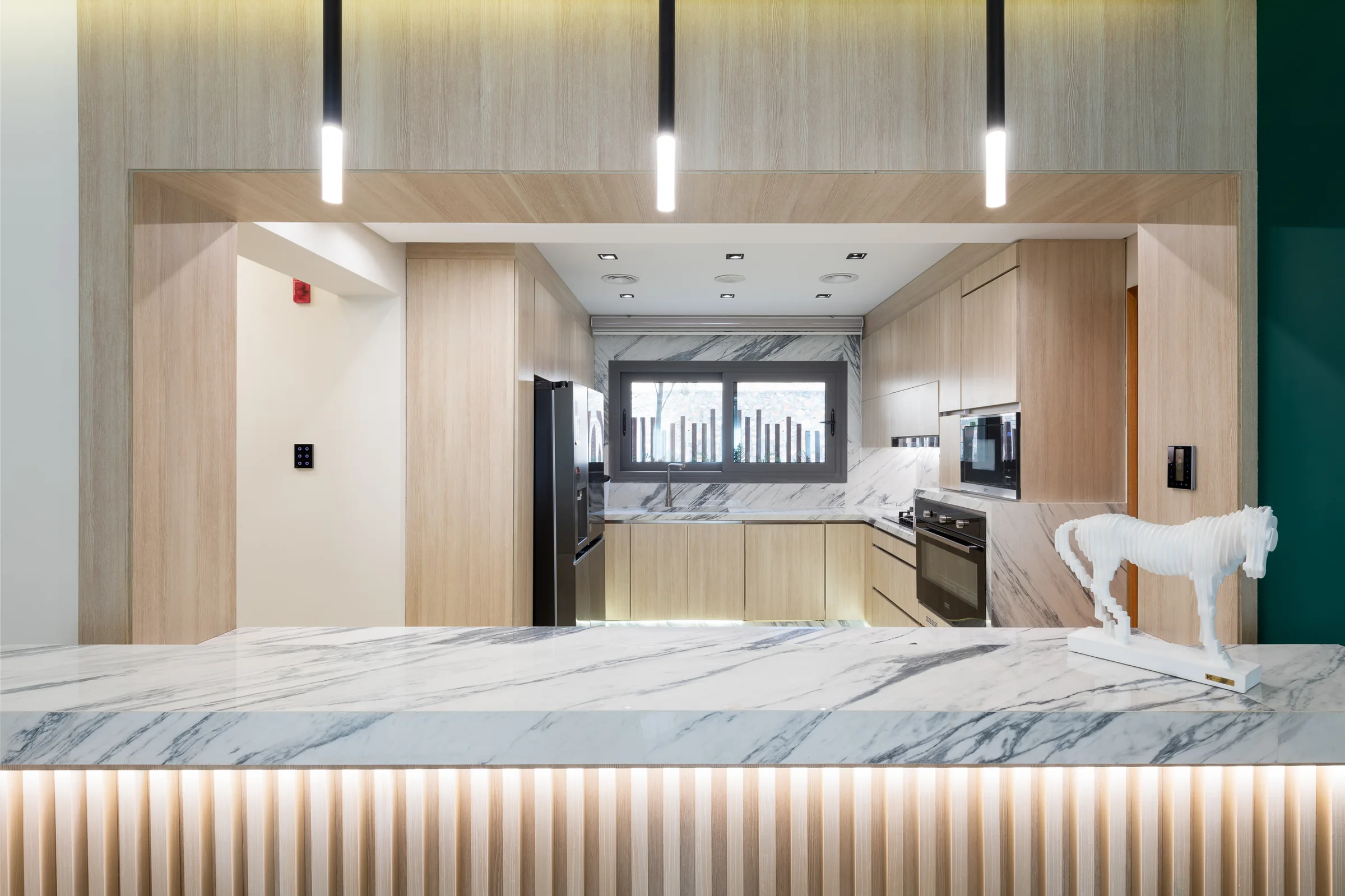Kitchen wide, marble island and full-height units.