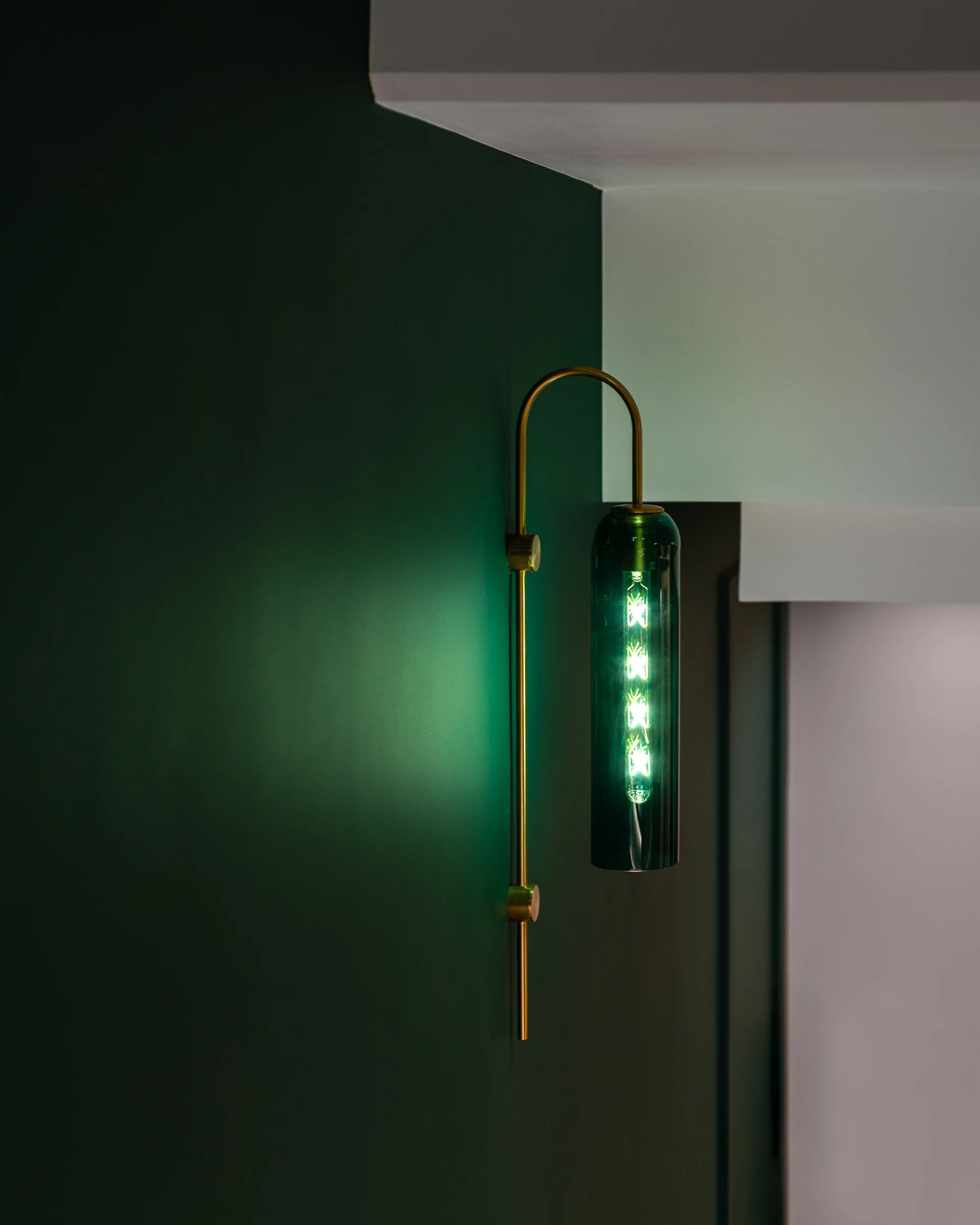 Brass sconce on the green wall, close.