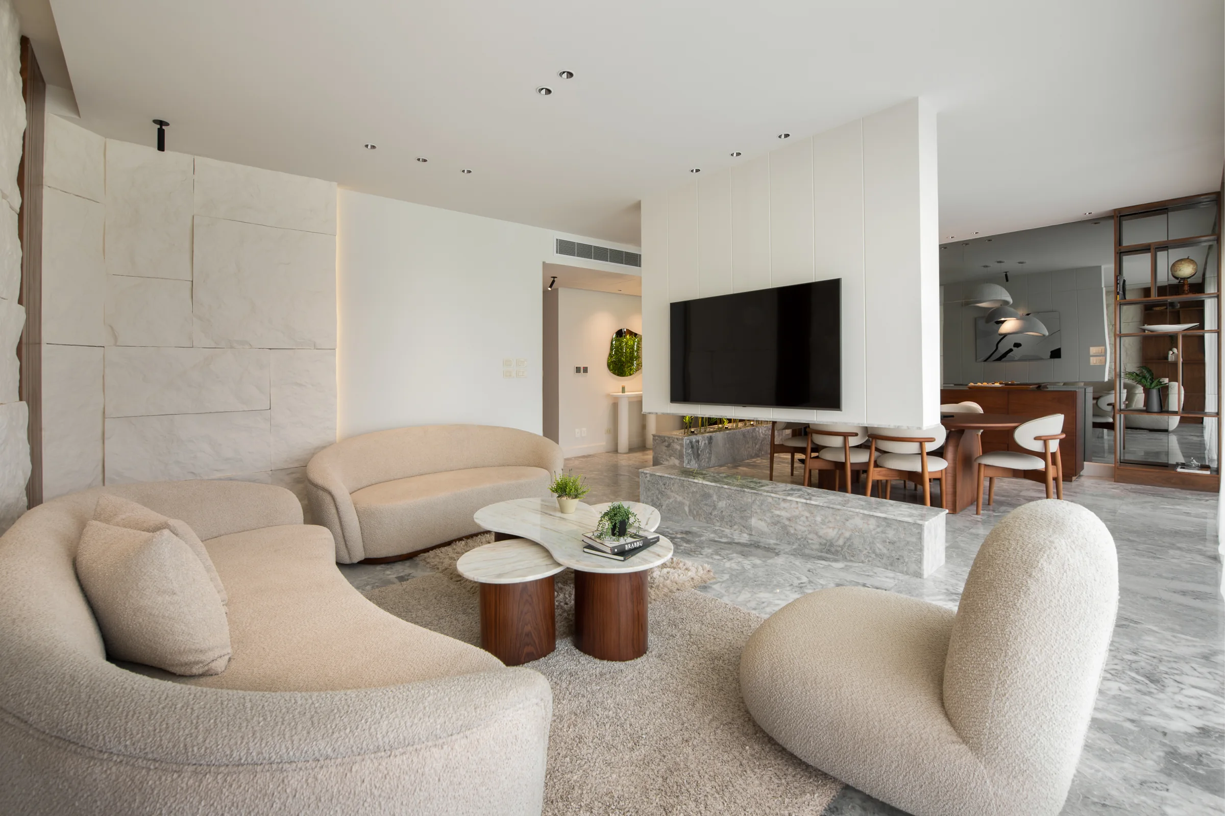 Wide living room with the television wall and dining beyond.