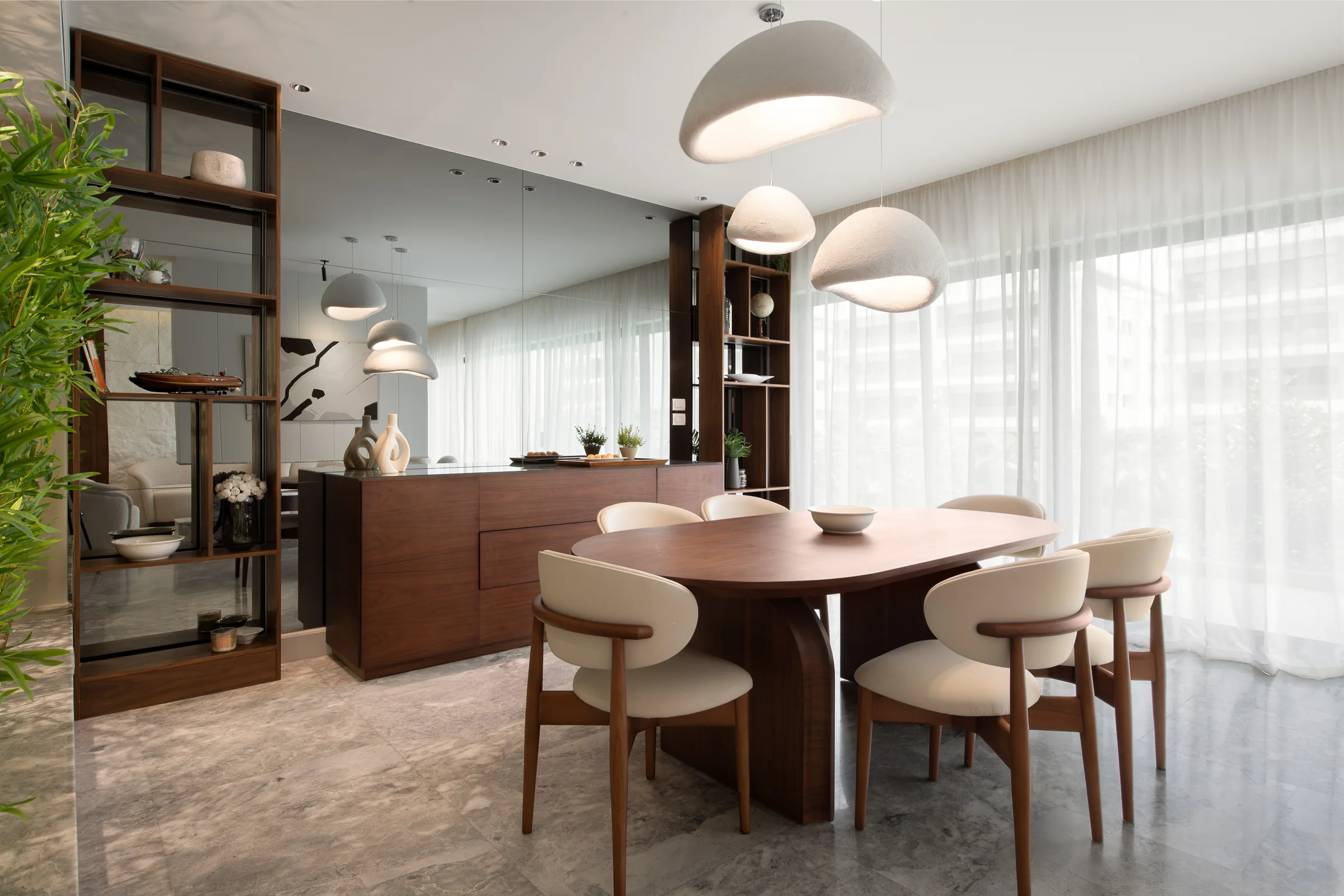 Dining room with dome pendants over a walnut table.