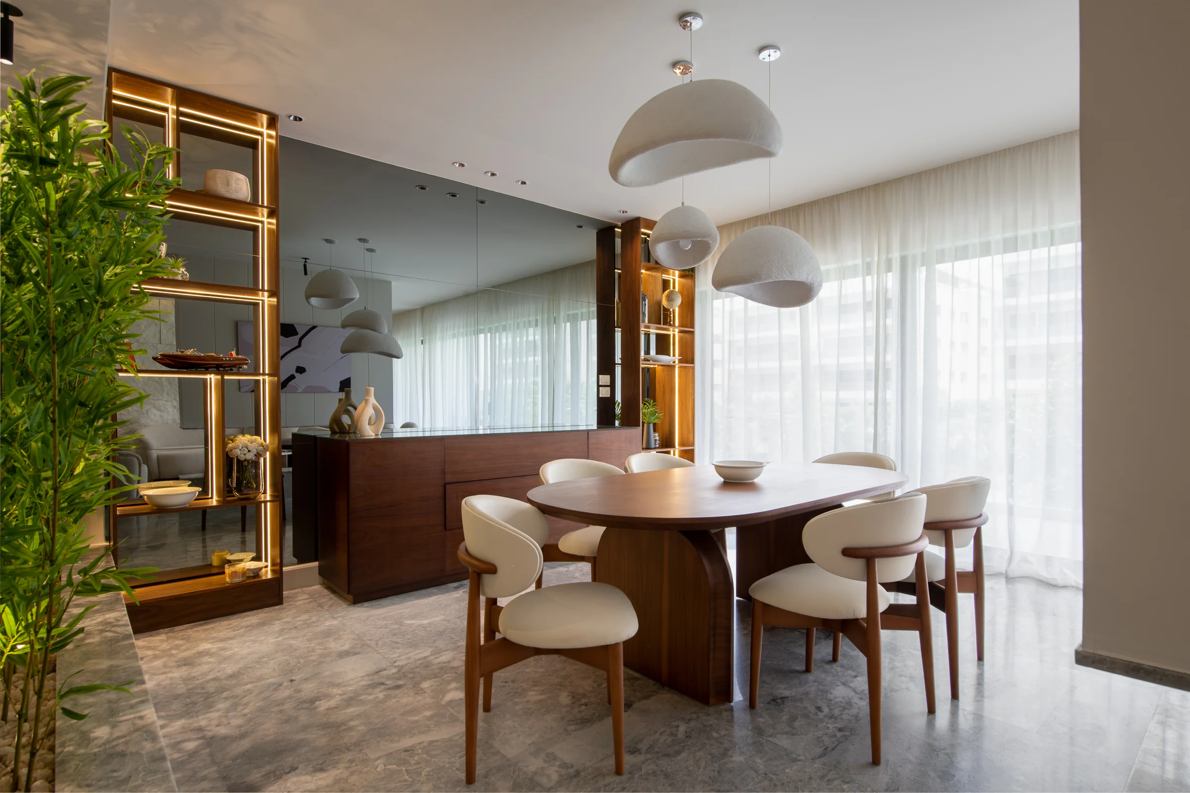 Dining room with a brass display screen and planting.