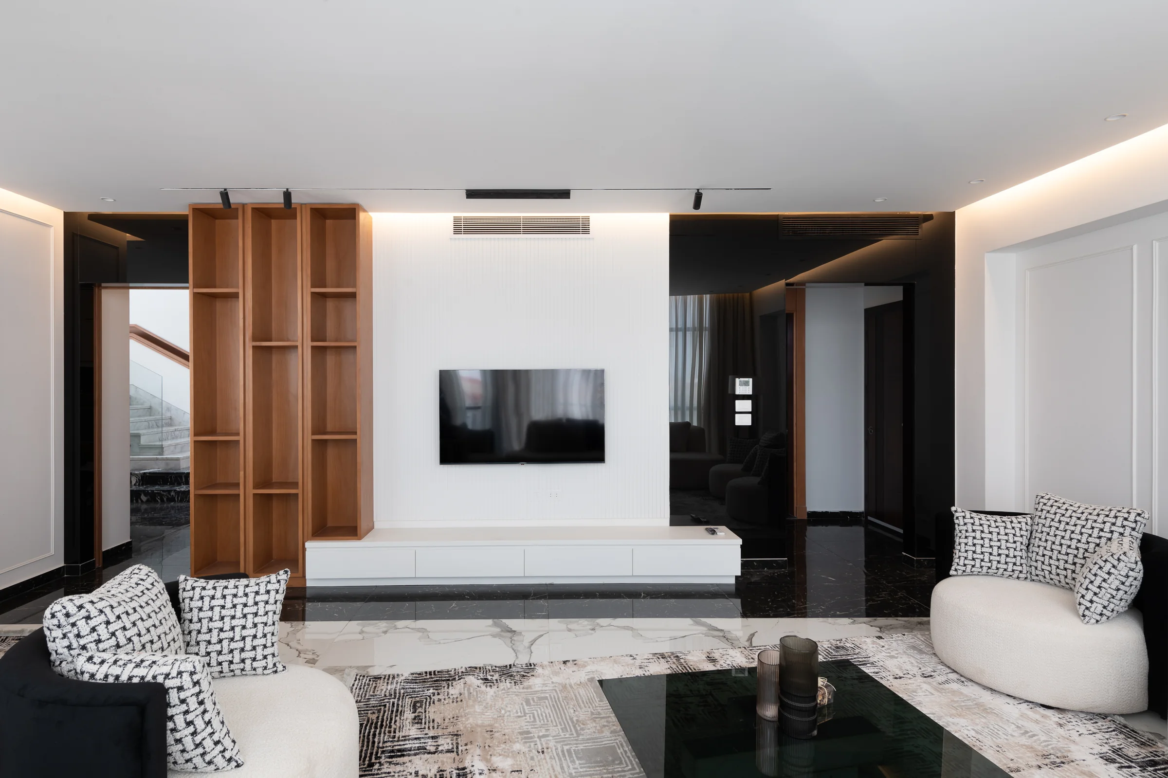 Living room from the joinery wall, black marble underfoot.