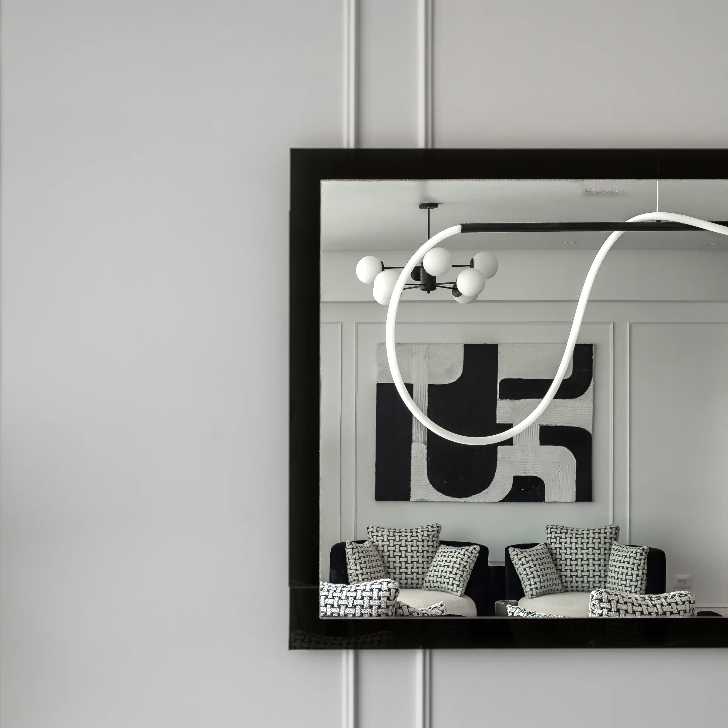 Framed artwork doubled in the mirror above the console.