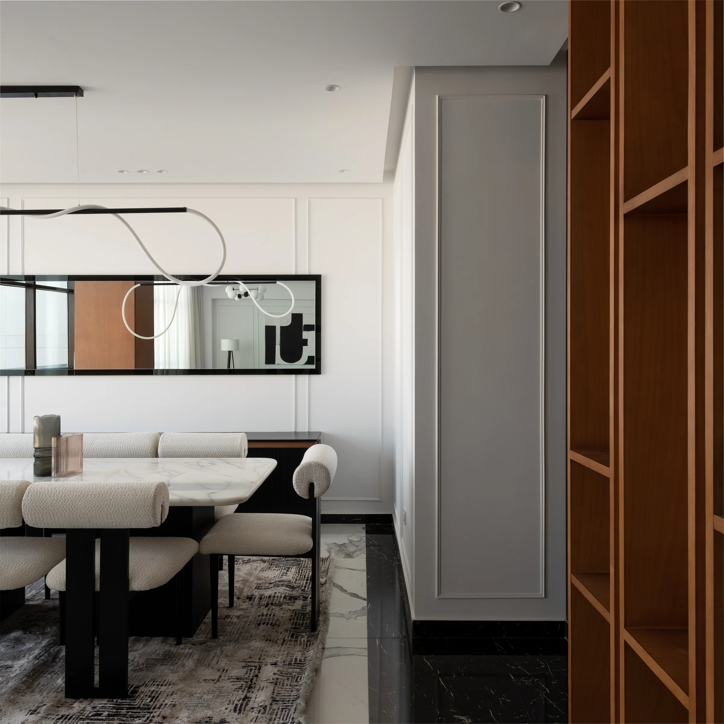 Dining corner with a mirror and walnut shelving.