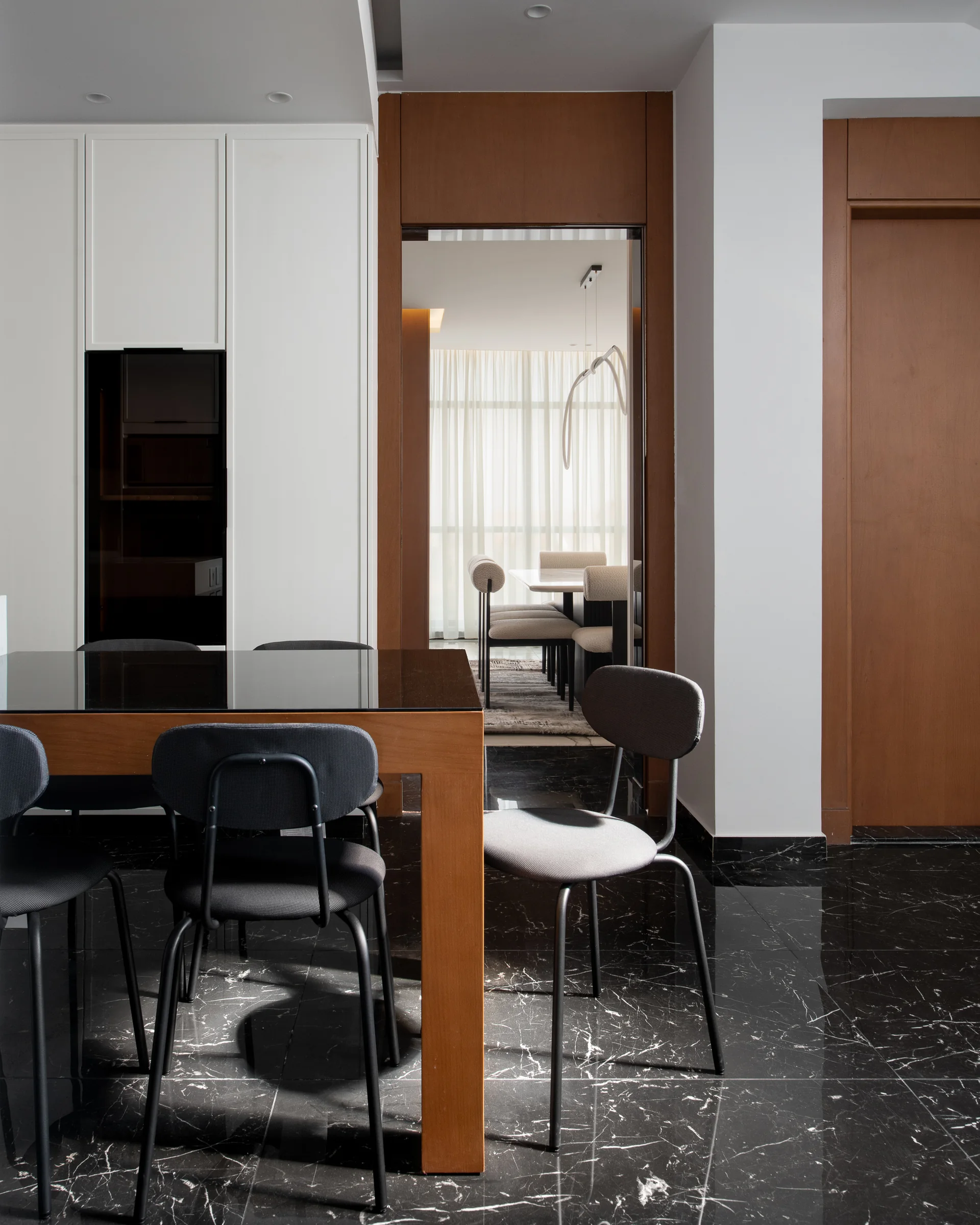 Dining table and chairs on black marble.