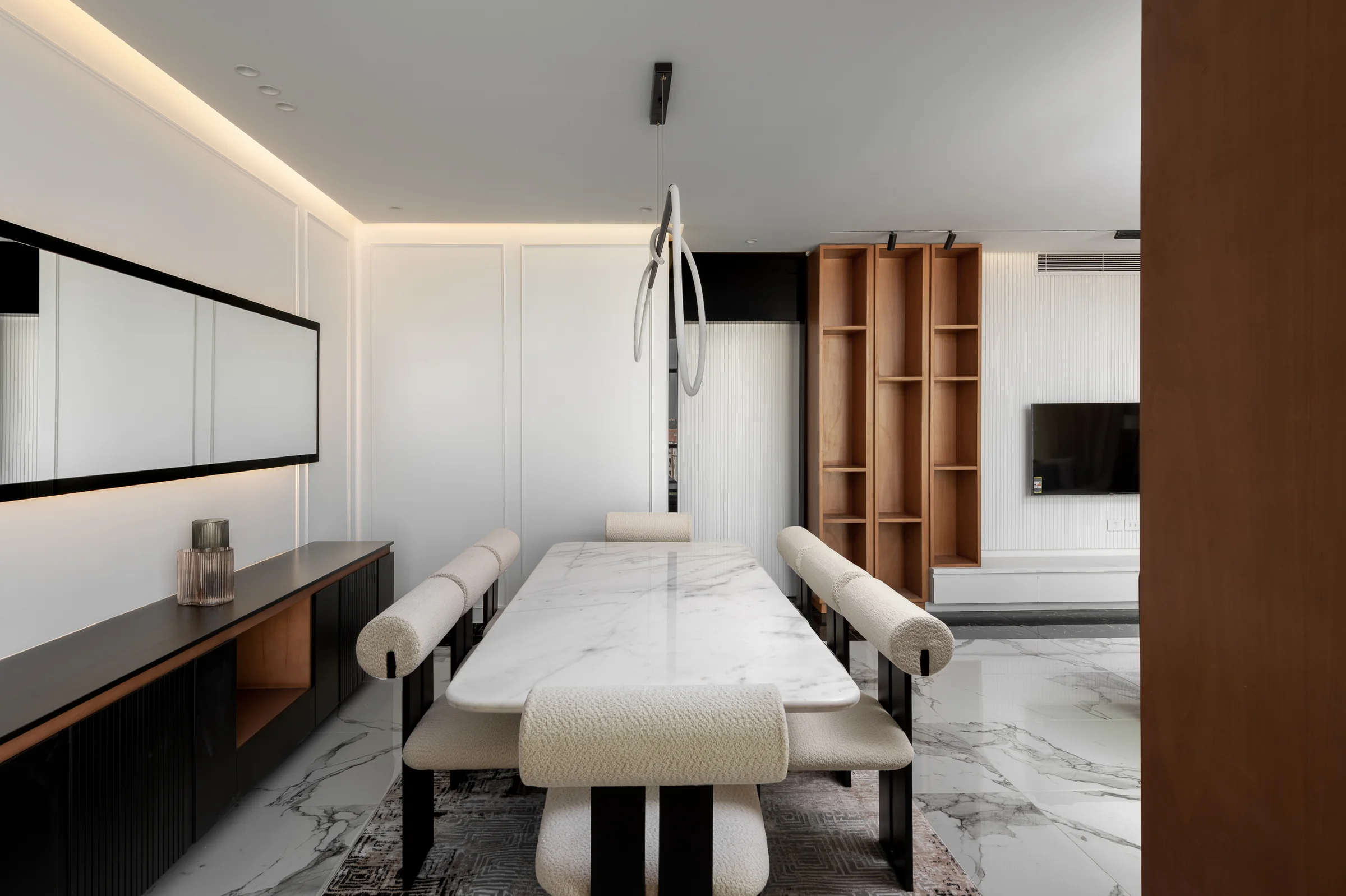 The long dining table with the mirror running behind it.