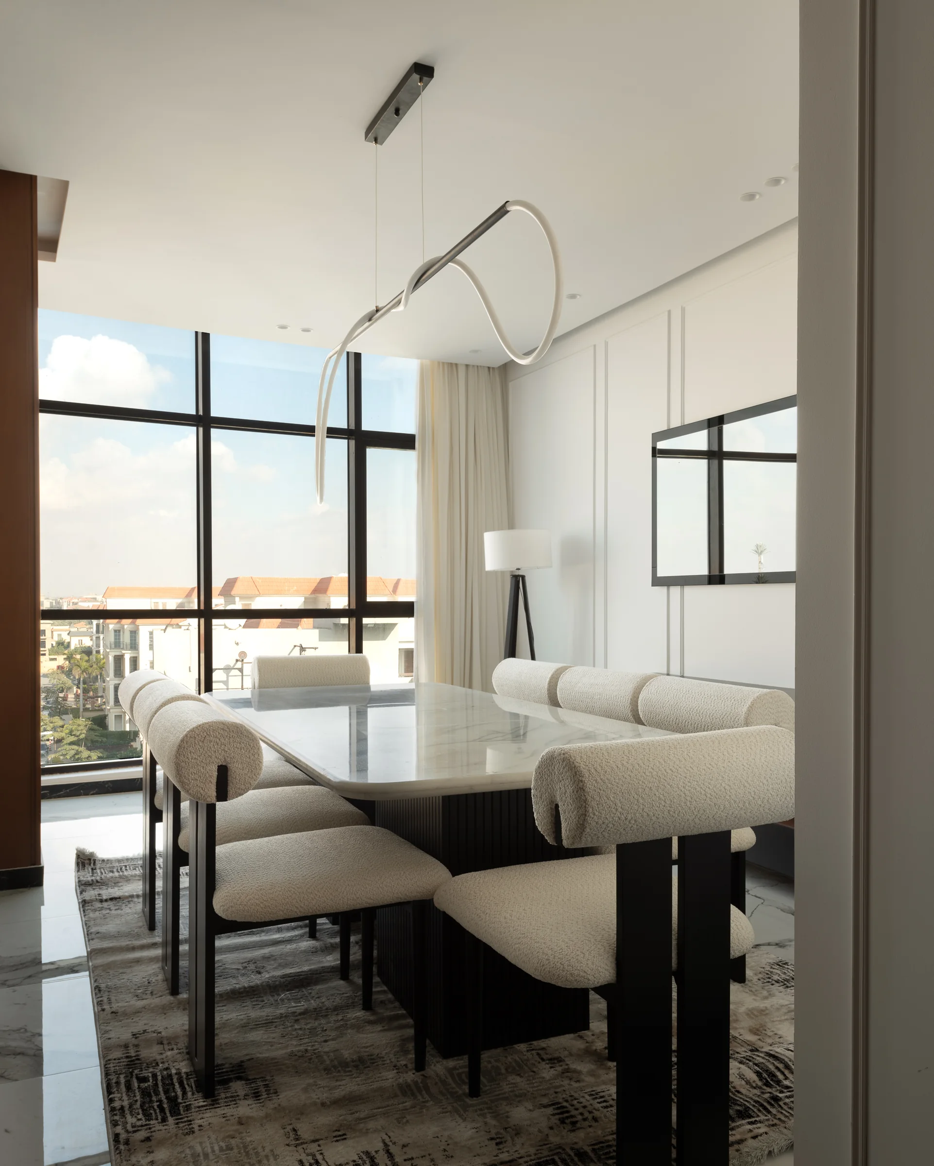 Balcony dining with the city beyond the glass.