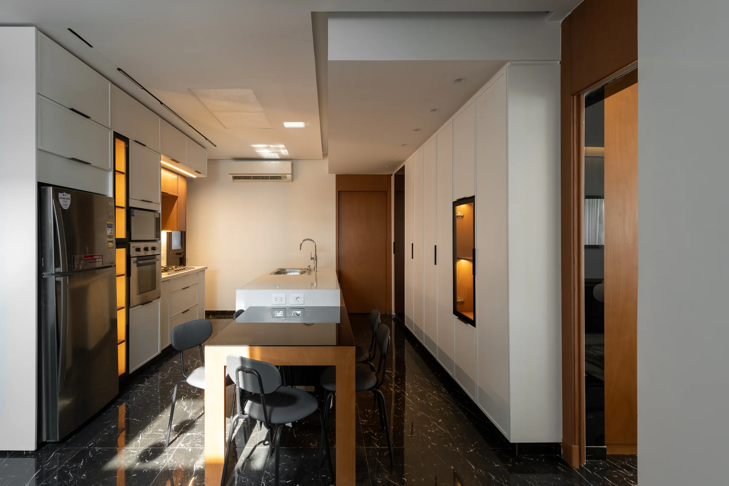 Kitchen from the doorway, light from the far window.