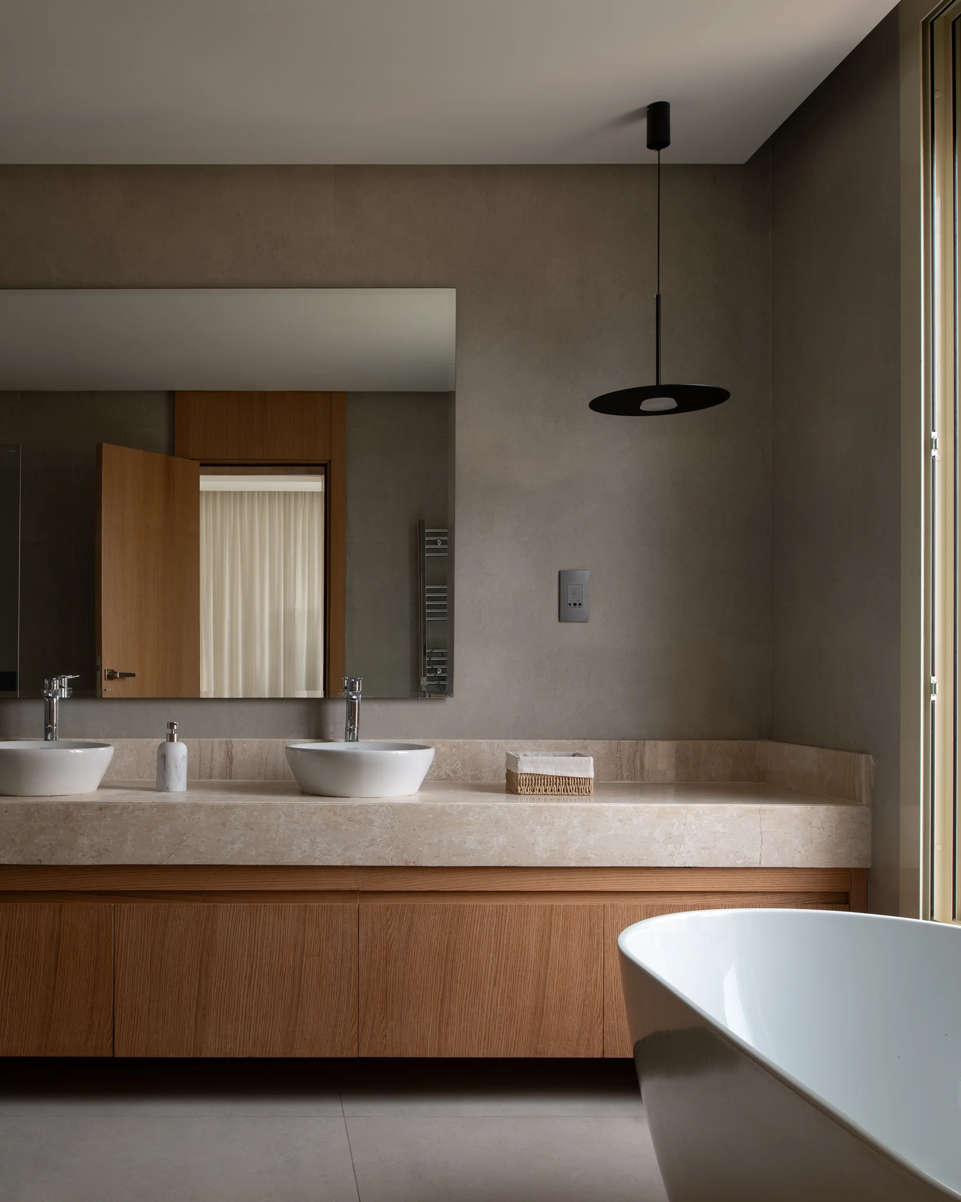 Master bathroom: travertine vanity, twin basins, freestanding tub.