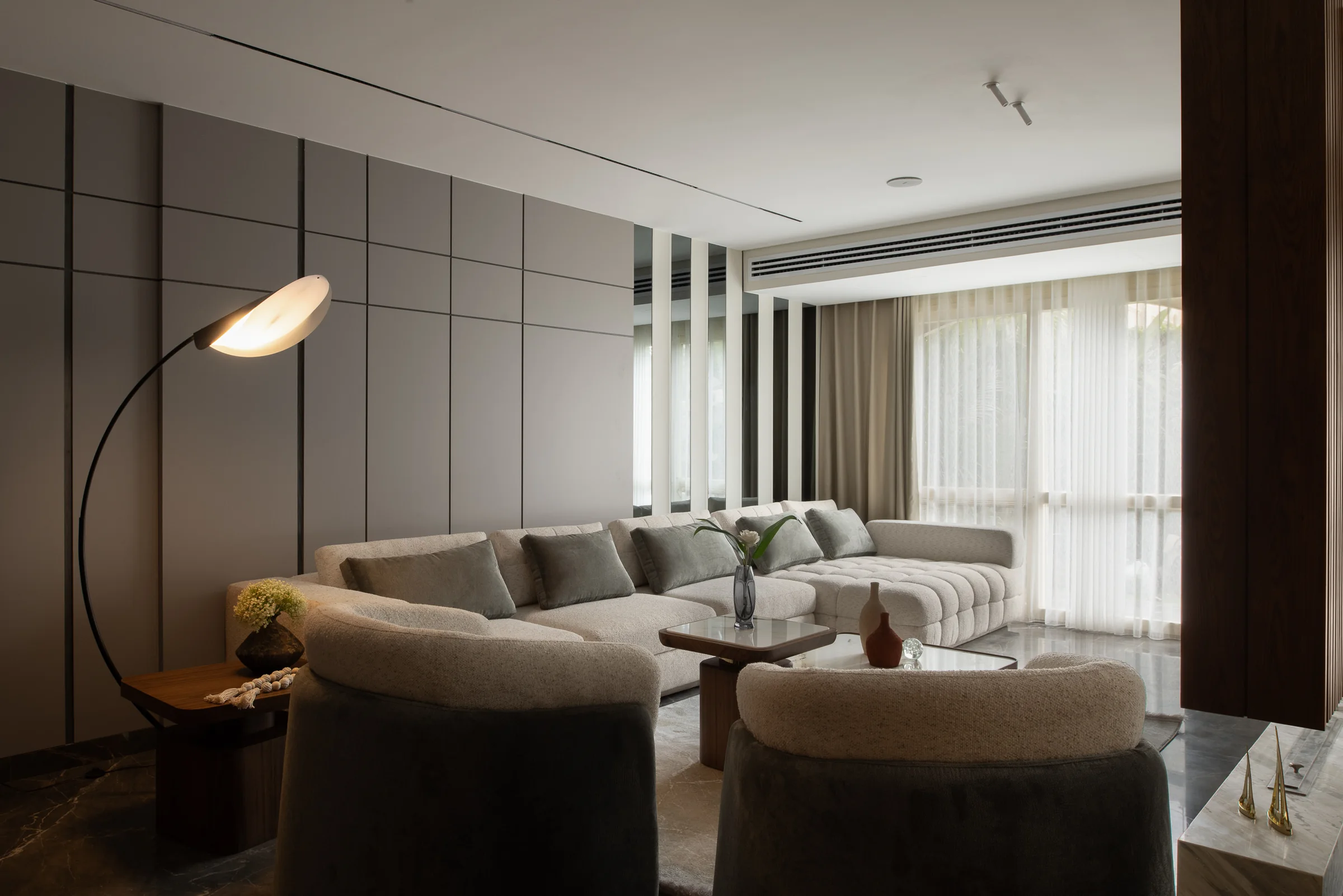 Living room from the far corner, arc lamp over the sofa.