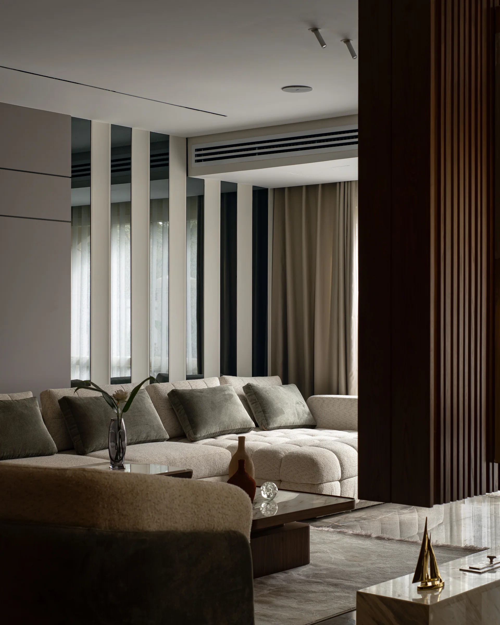 Sofa and side table with vertical timber fins along the window.