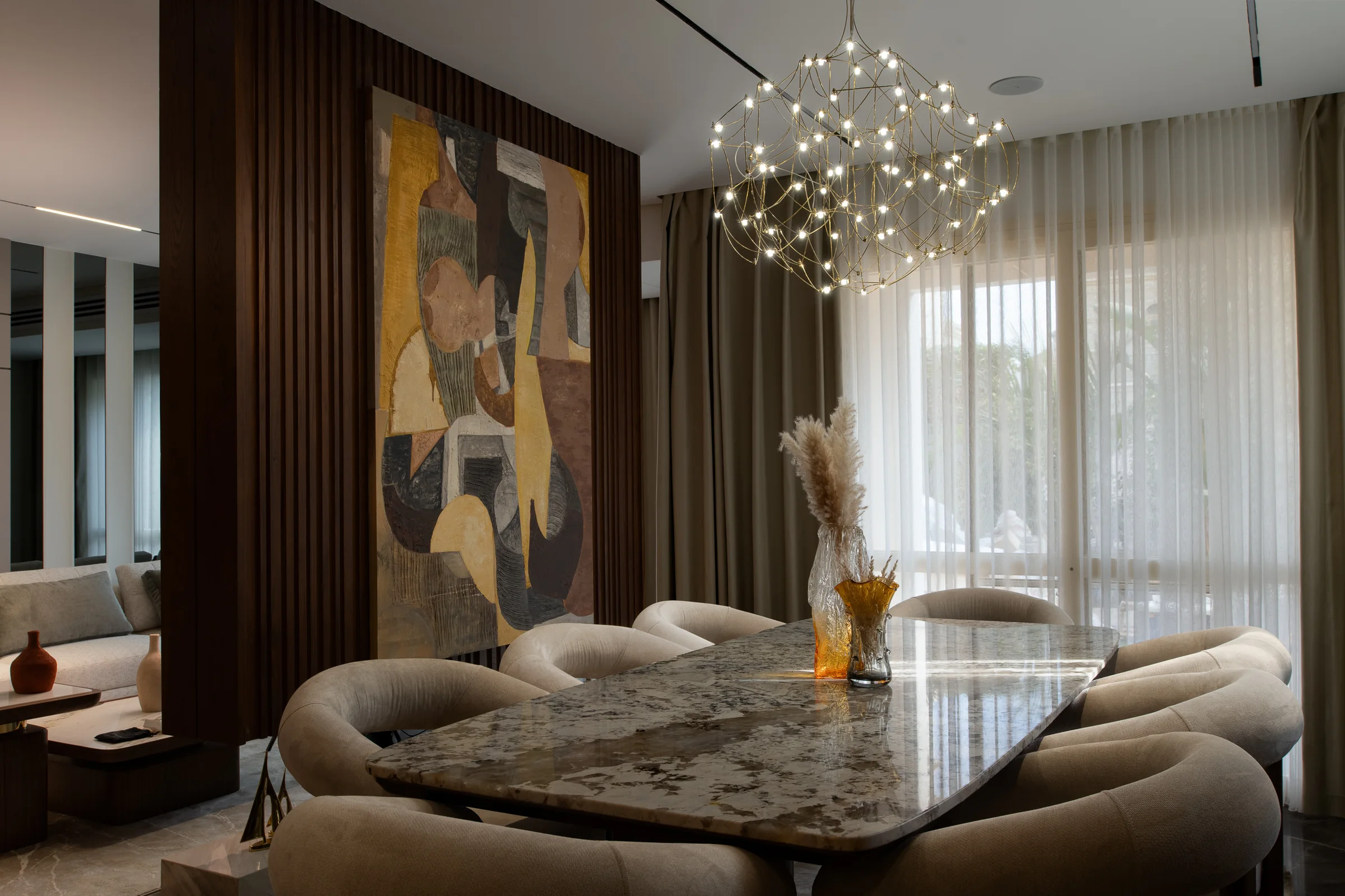 Dining table from the head, pendant reflected in the stone top.