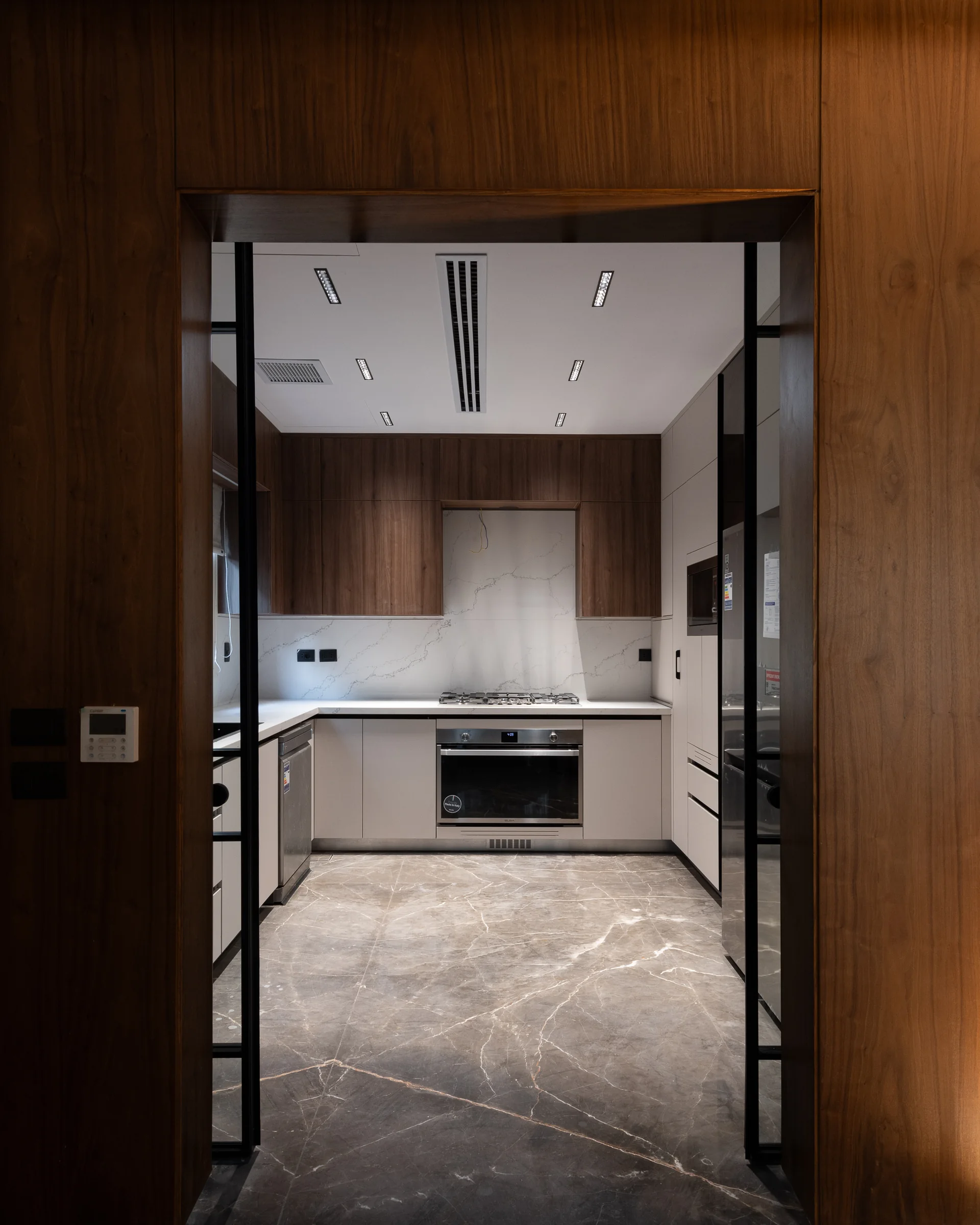 The same doors open, kitchen revealed.