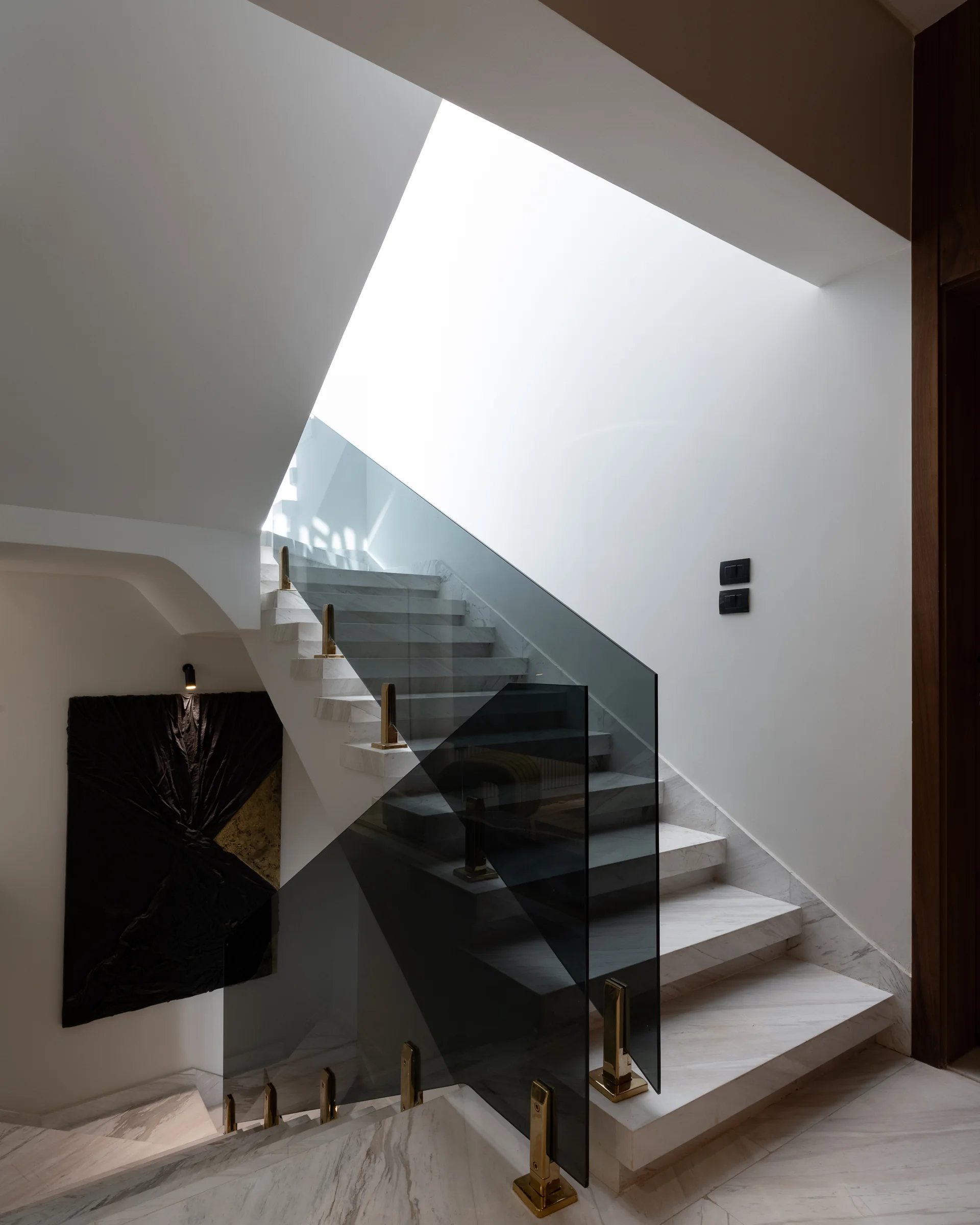 The stair under daylight, cool and near-white.