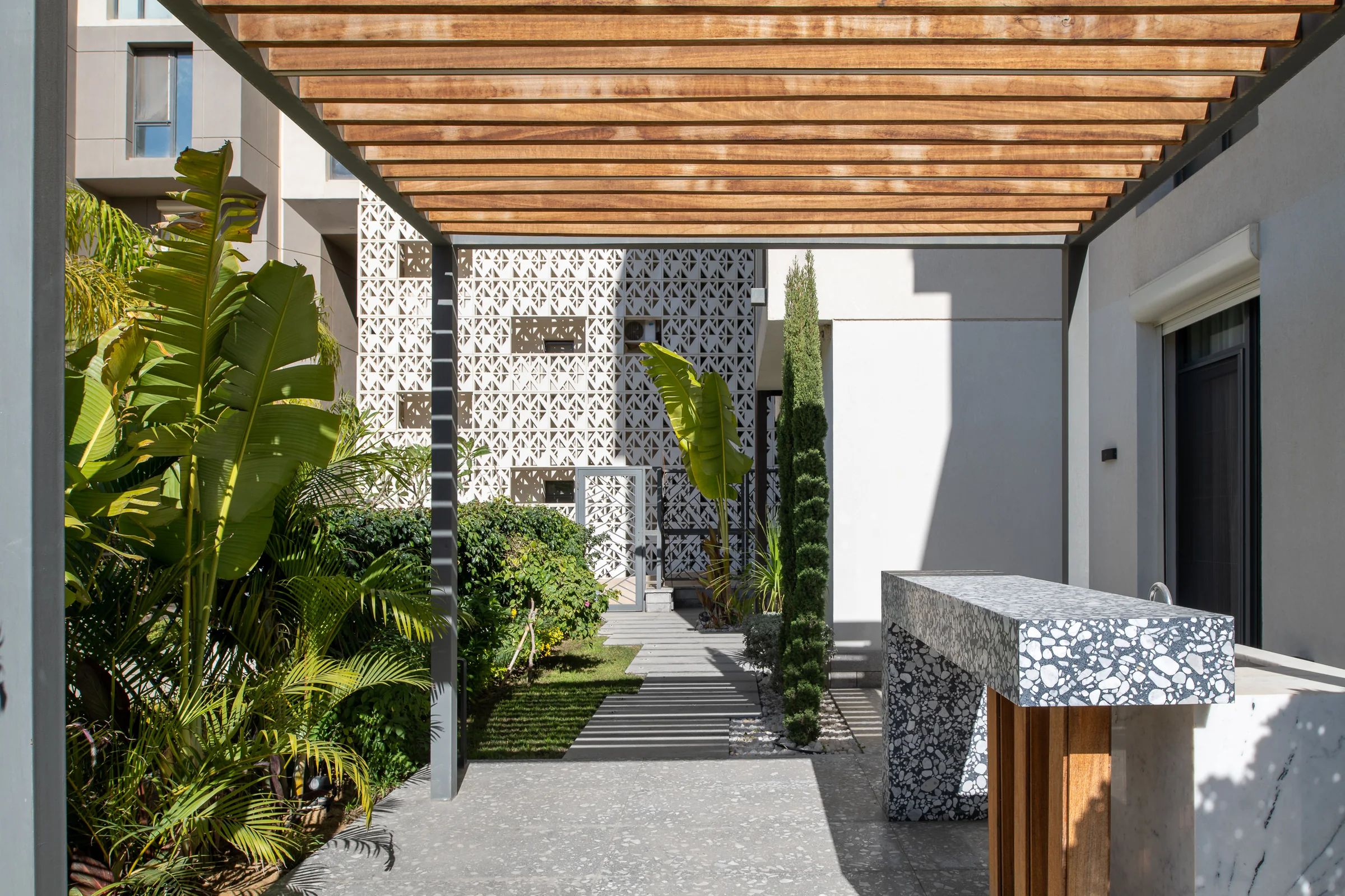 The courtyard by day, timber slats overhead.