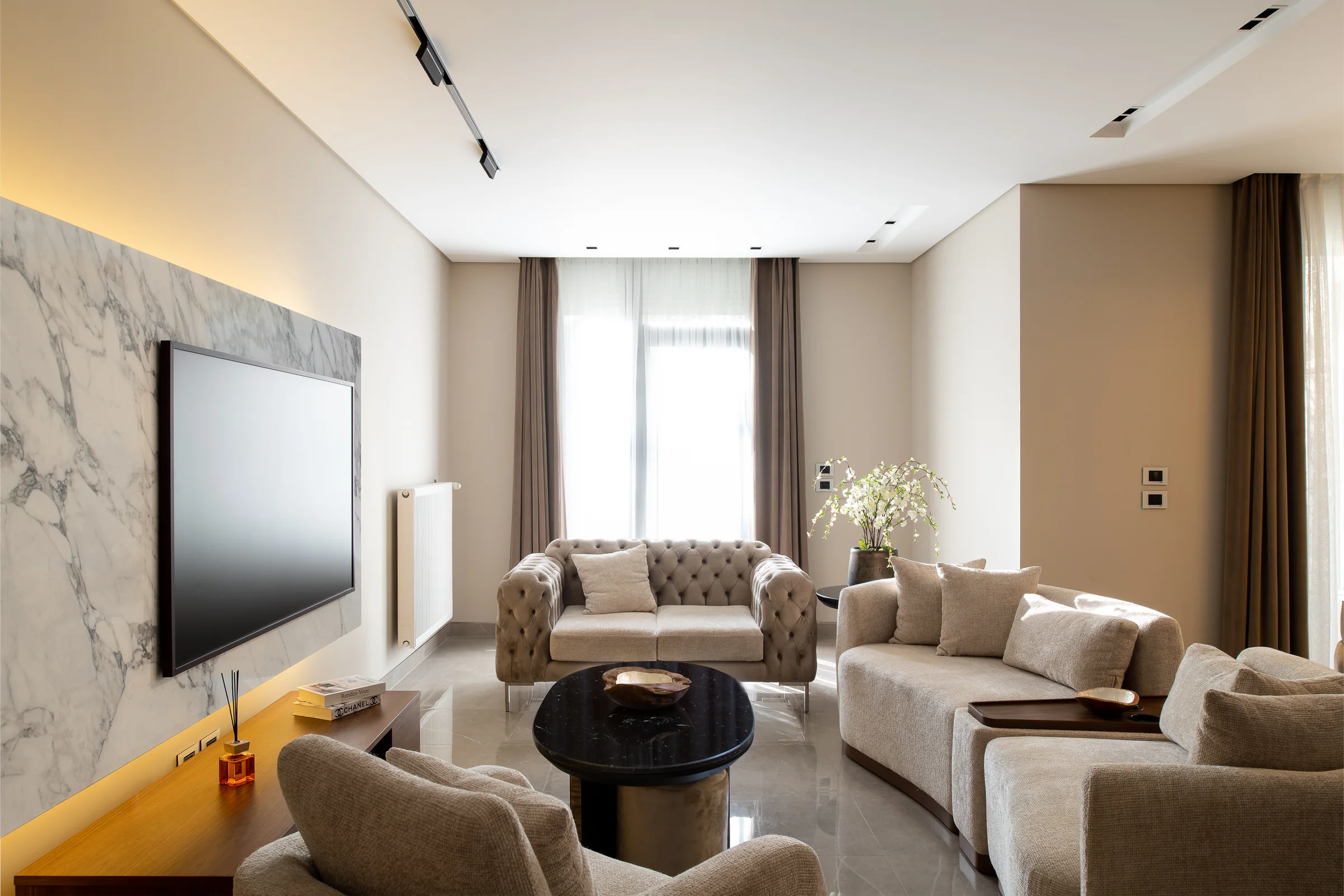 Living room from the corner with the window wall beyond.