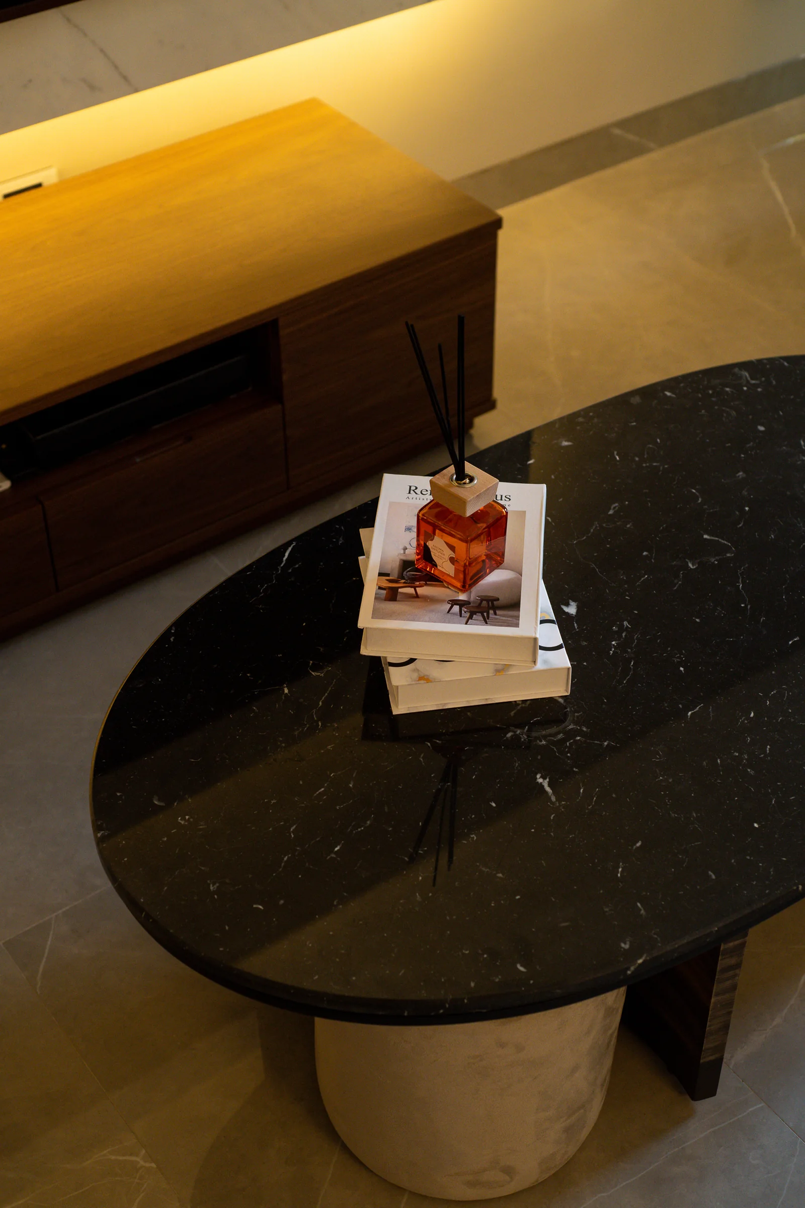 Black stone table with books and a diffuser.