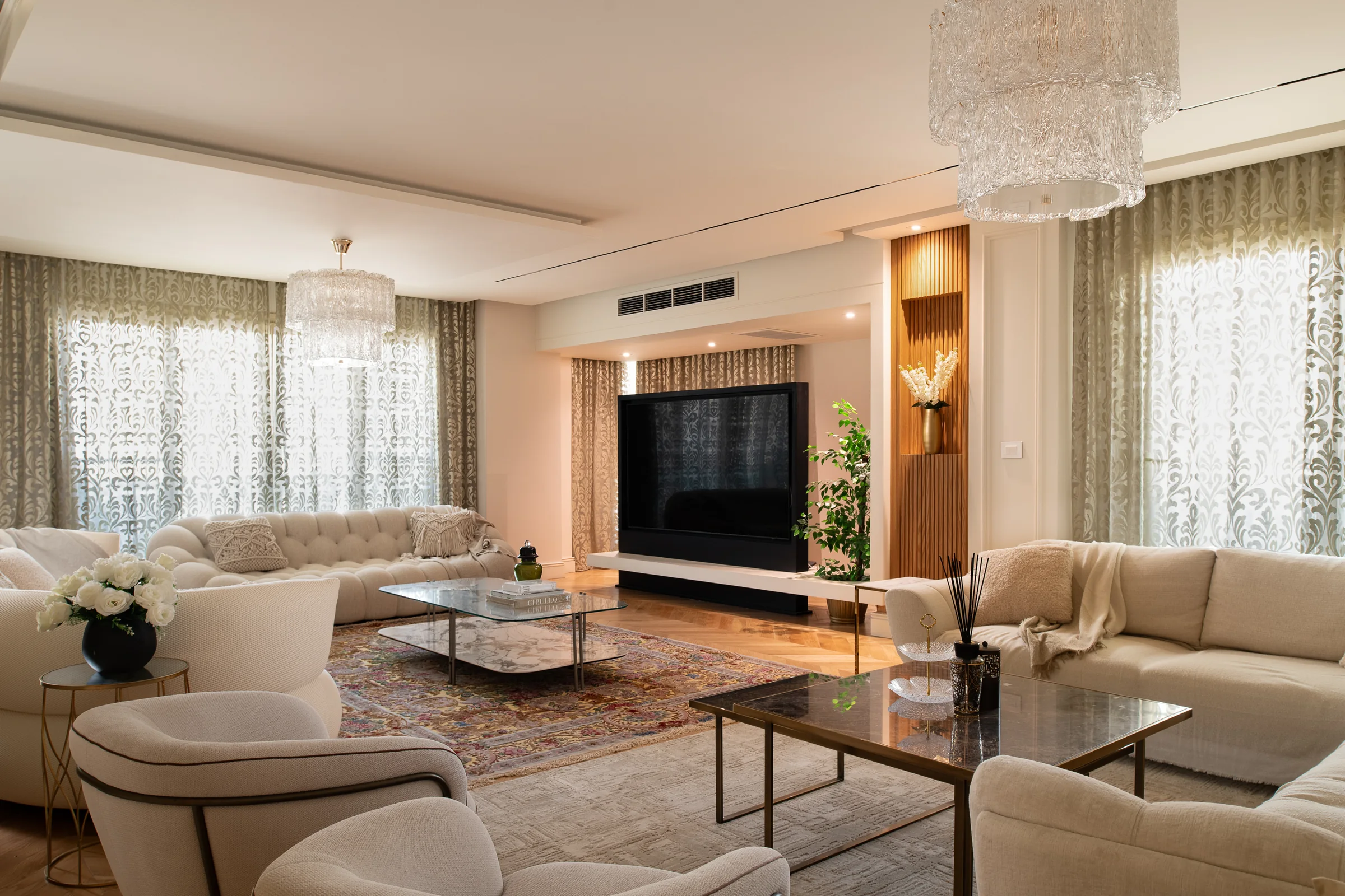 Living room with the television wall between two window bays.
