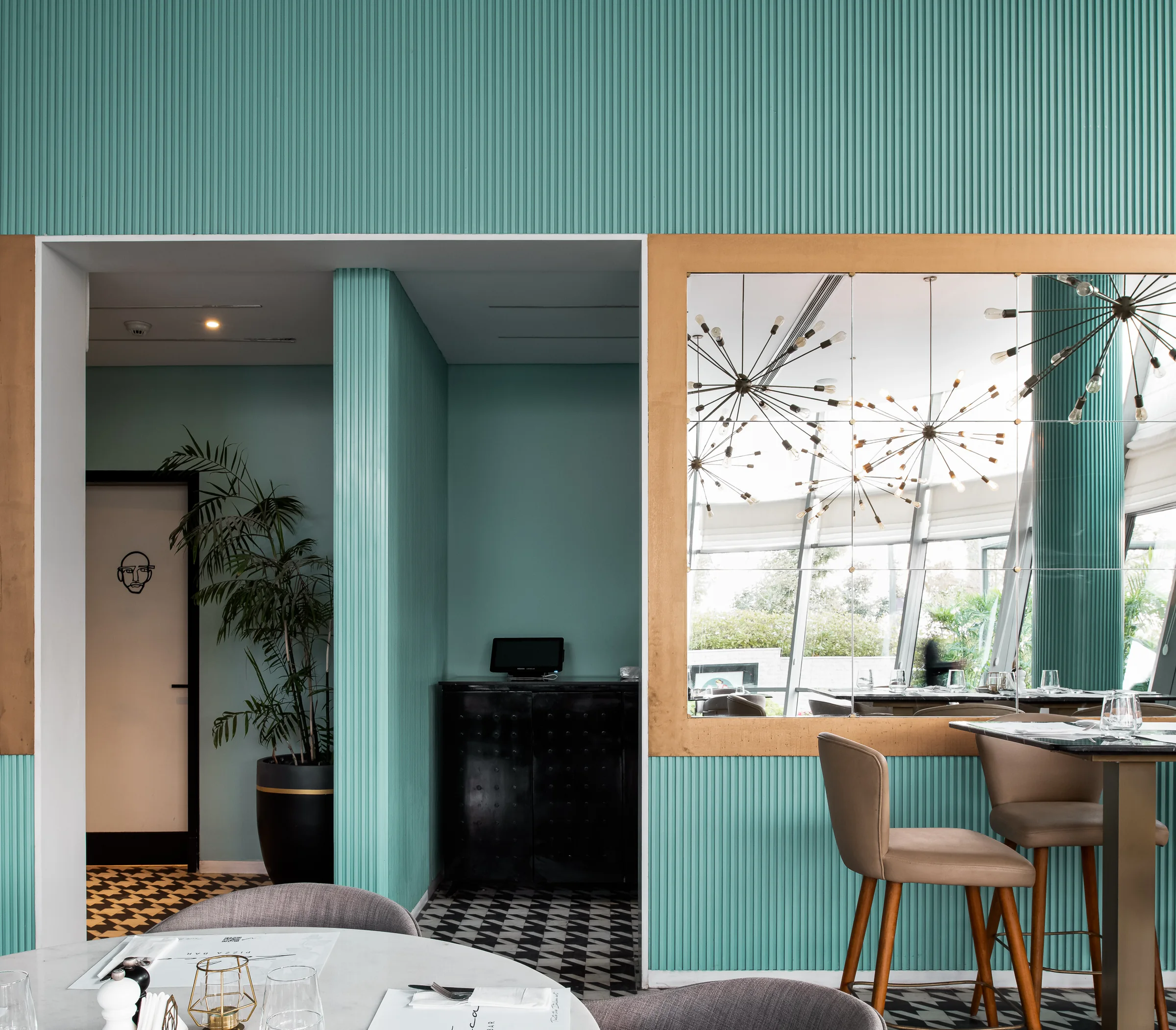 Corner table for two against ribbed teal panelling.