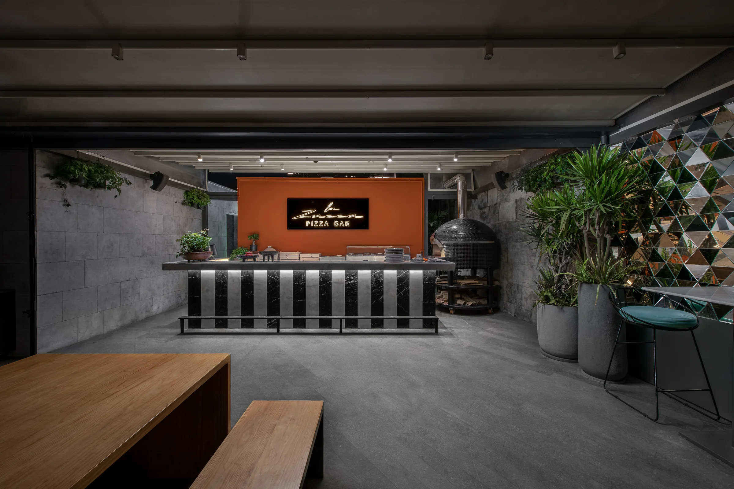The pizza bar counter against a burnt-orange wall.