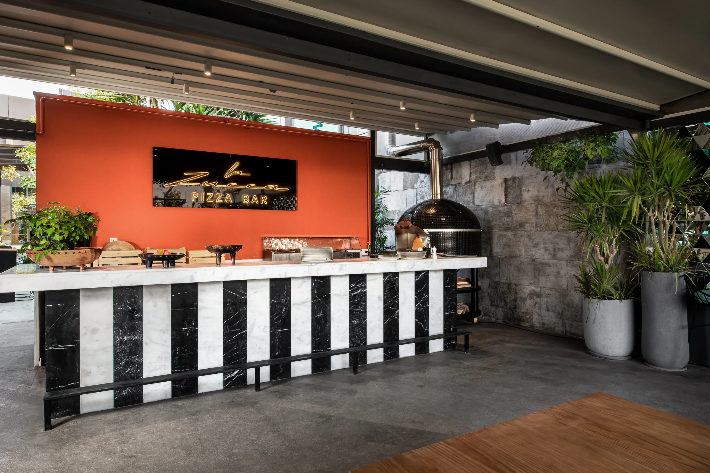 The pizza bar full length, dough station and wood oven.