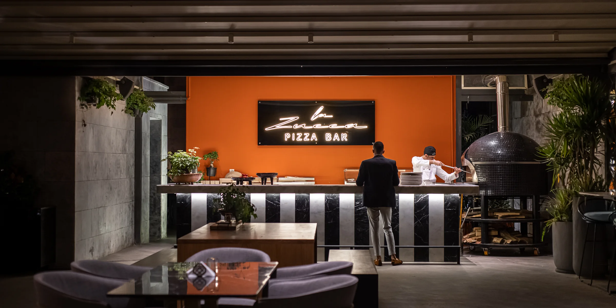 The pizza bar in service, seen wide and low.