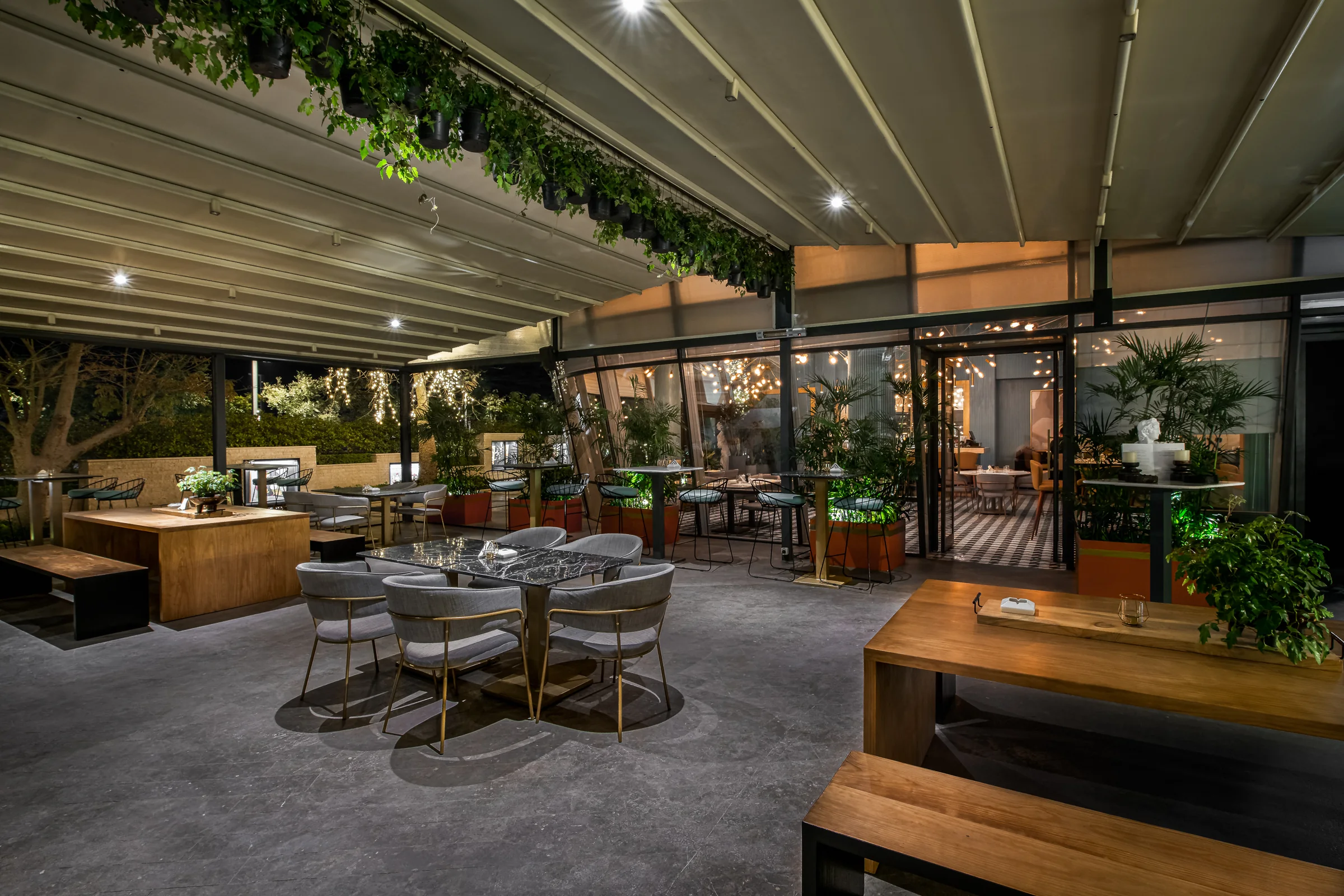 Terrace seating under the pergola, planting overhead.